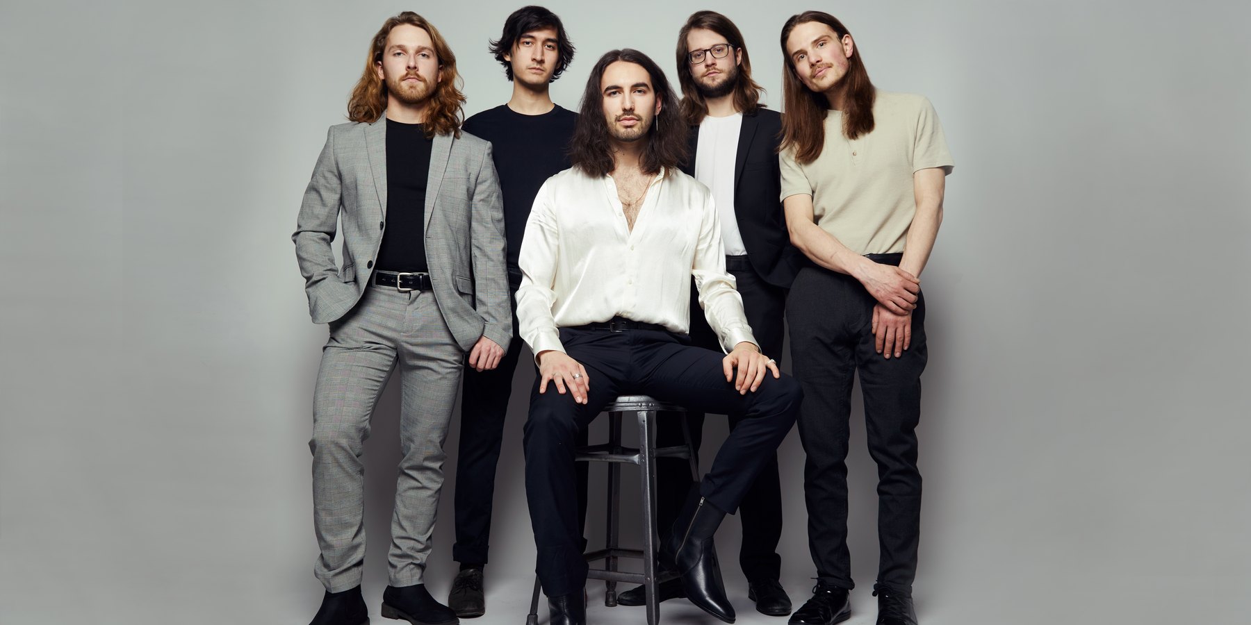 Carter and the Capitals — band portrait, five on grey with a stool, Edmonton