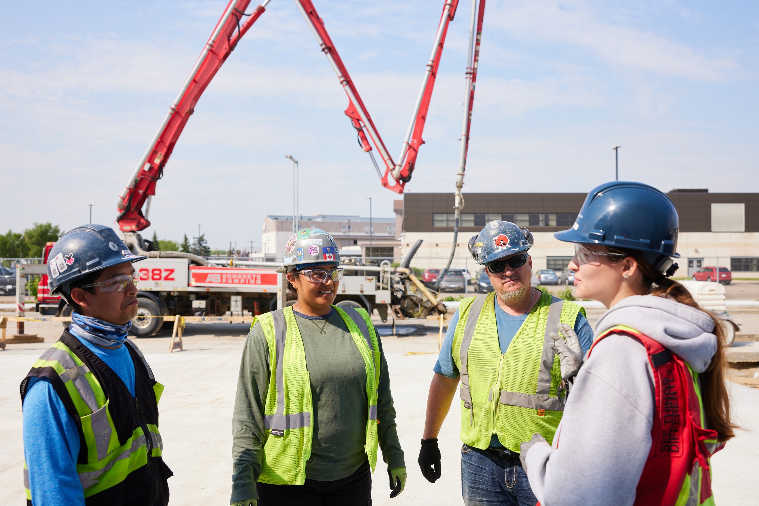 A crew under the arms of a concrete pump