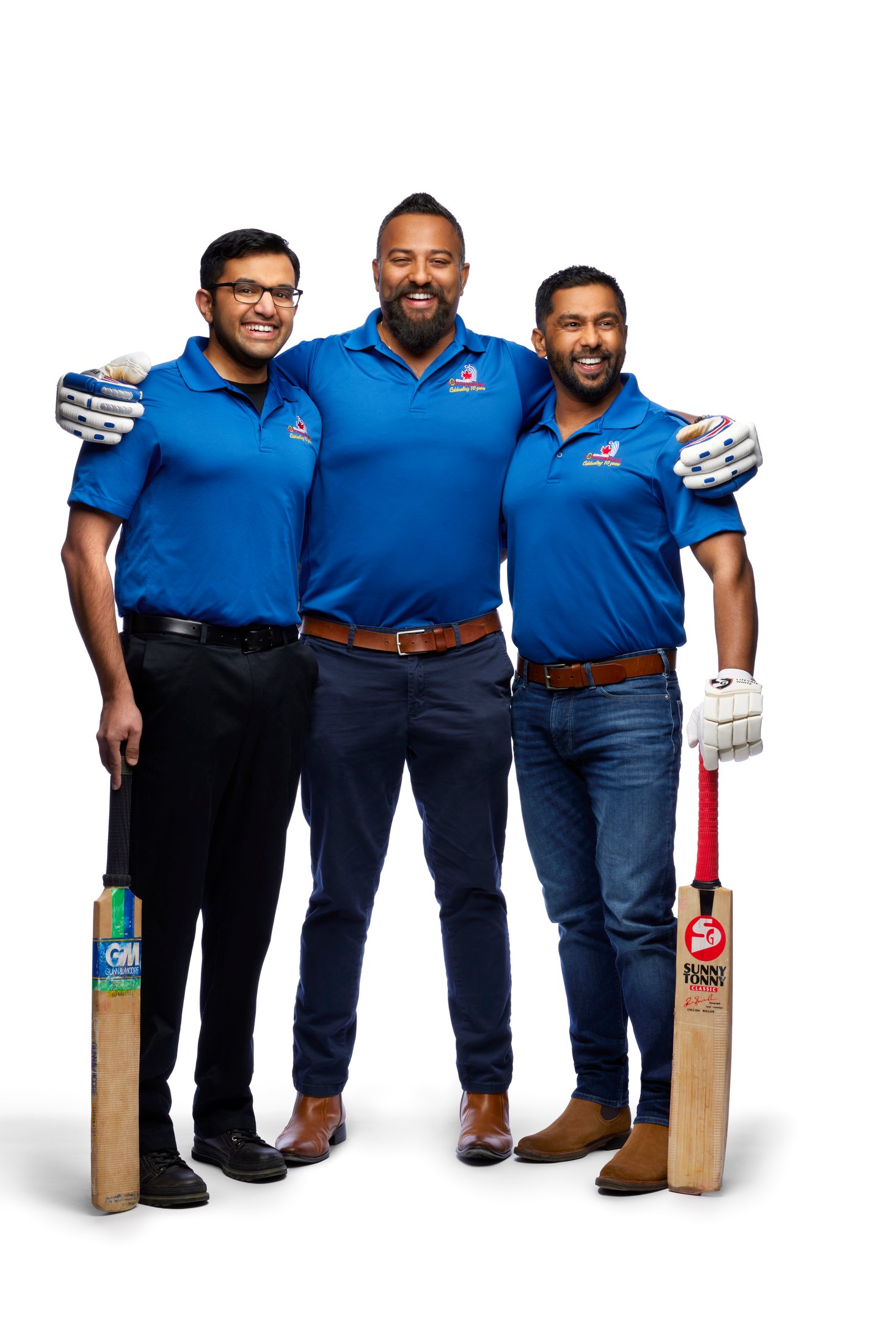 Three cricket players in team blue with bats, cut out on white