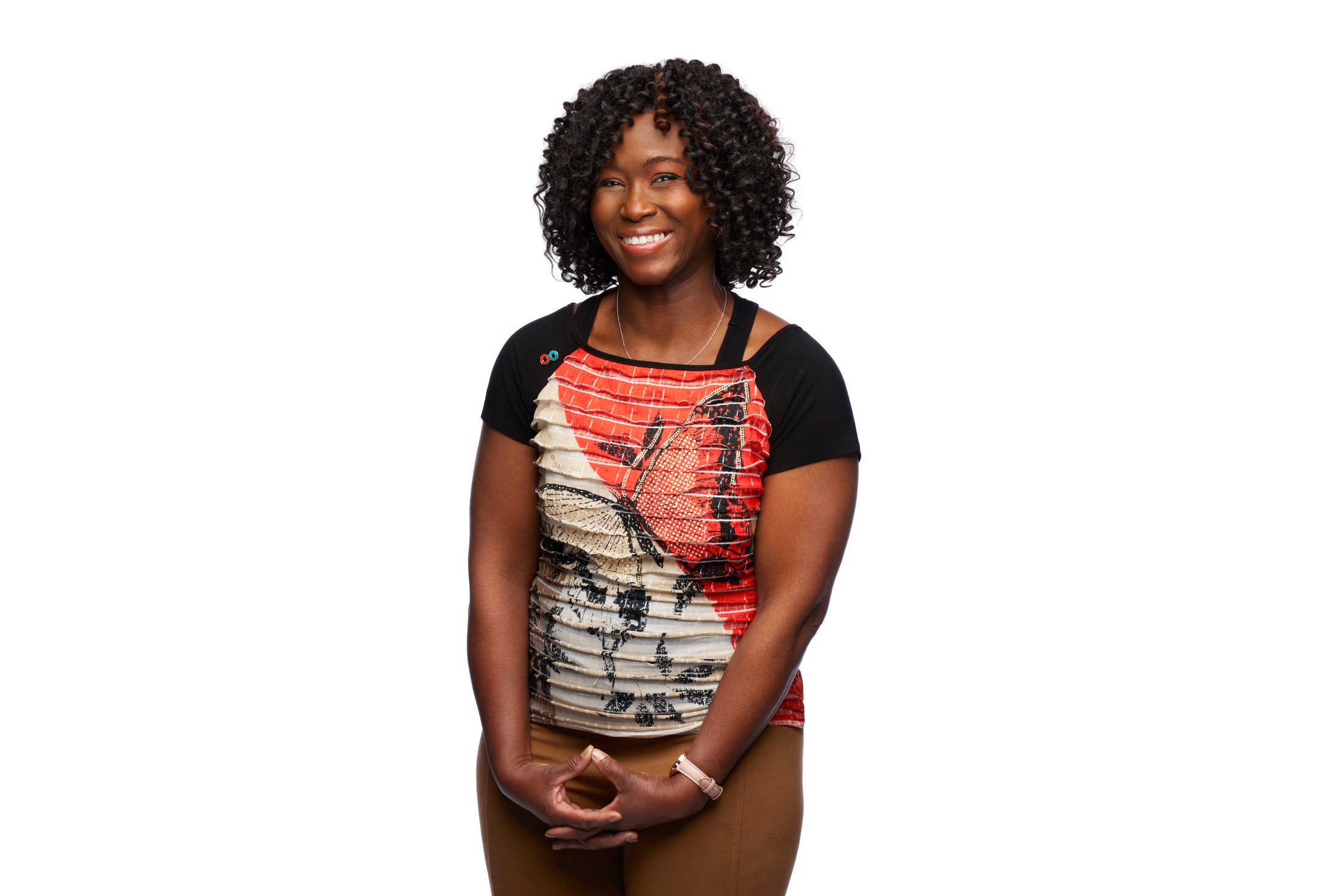 A woman in a printed tee, hands together