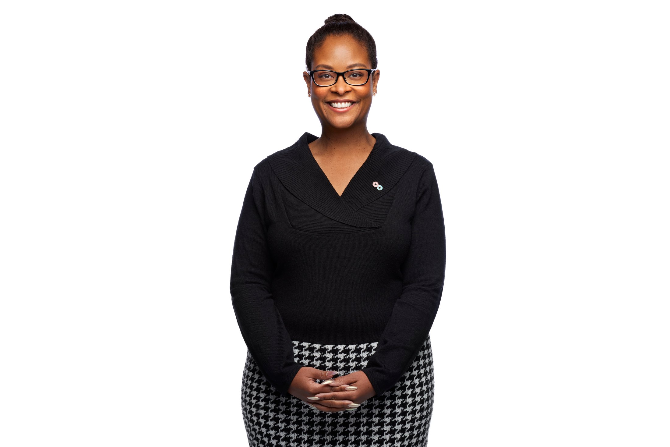 A woman in a dark quarter-zip against white
