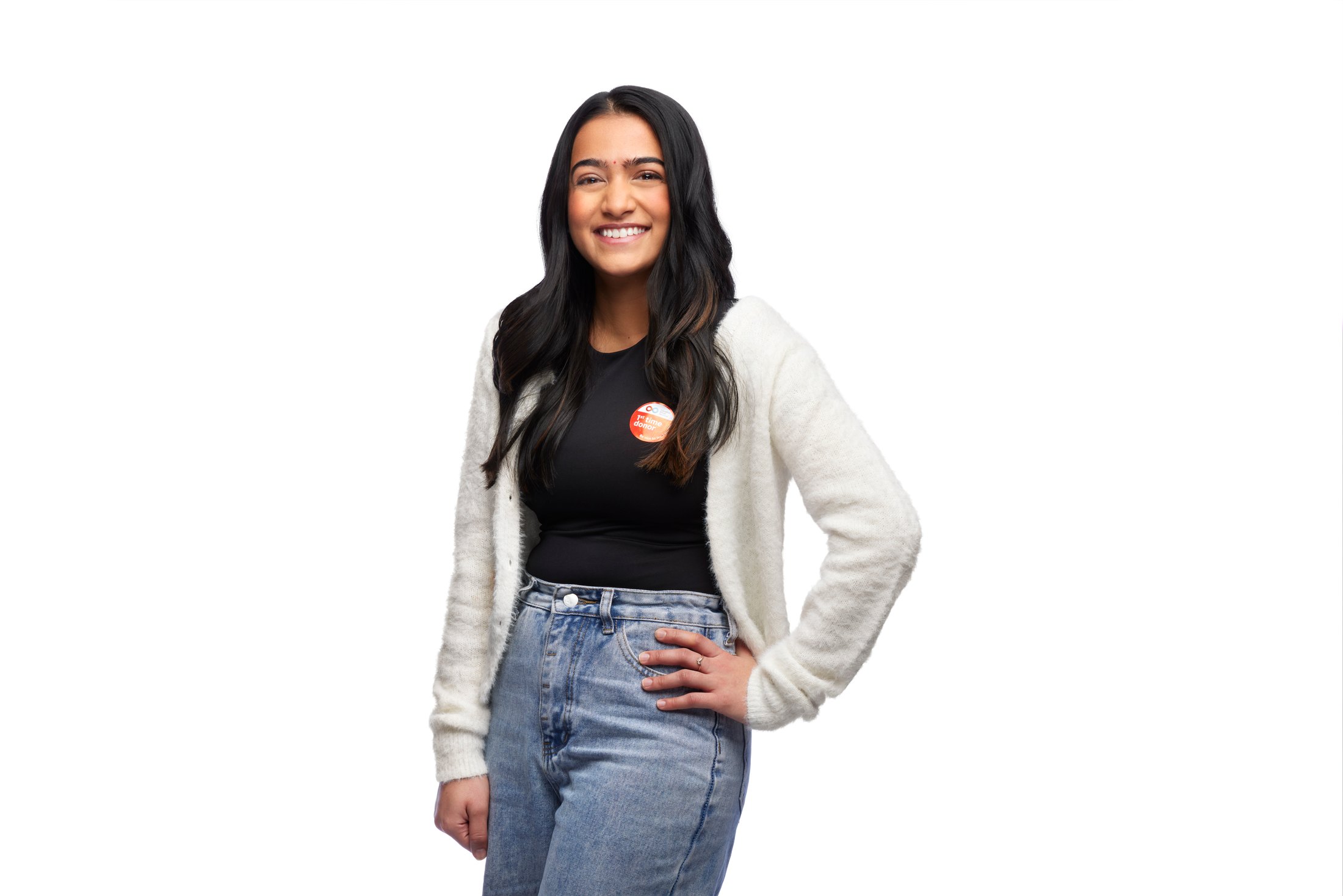 A woman in a white sweater, a hand on her hip