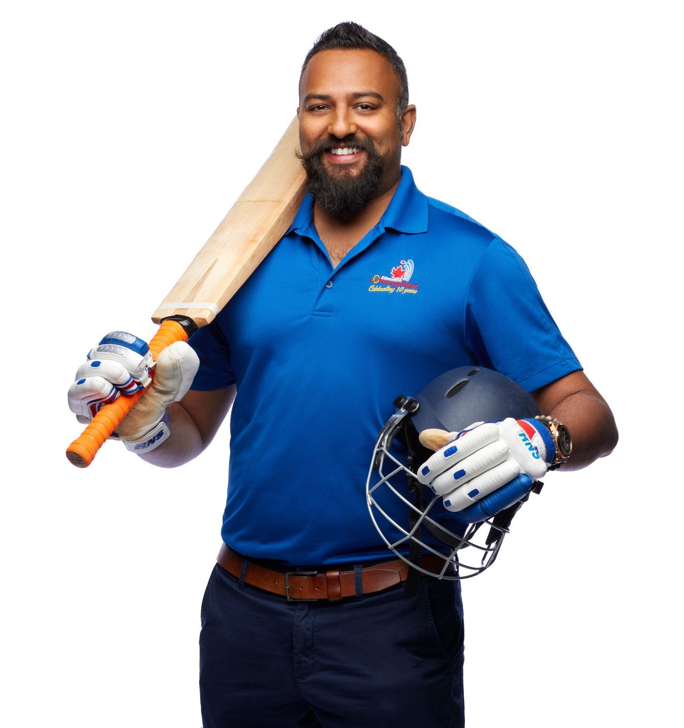 A cricket player with his bat over his shoulder and helmet in hand