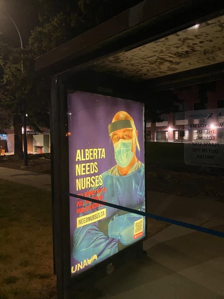 The poster in another bus shelter at night
