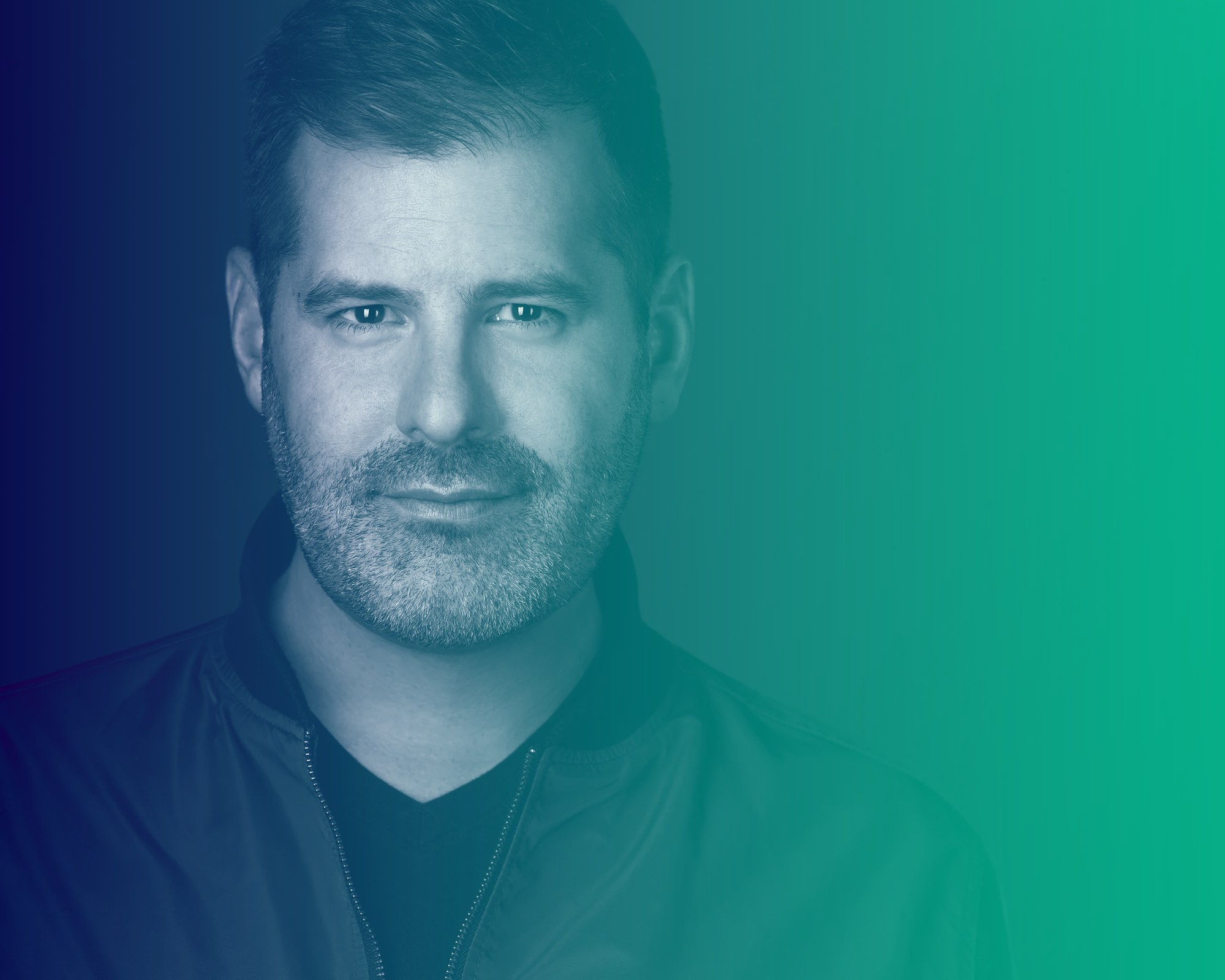 Ryan Jespersen, host of Real Talk, under a navy-to-green wash — commercial portrait by Ryan Parker