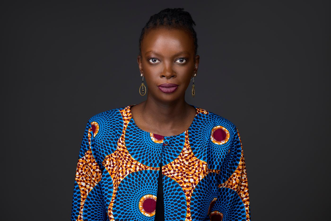 Business headshot, a bold print jacket on charcoal