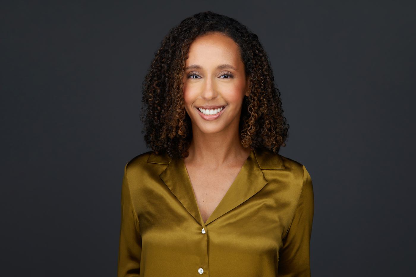 Business headshot, an olive silk blouse on charcoal