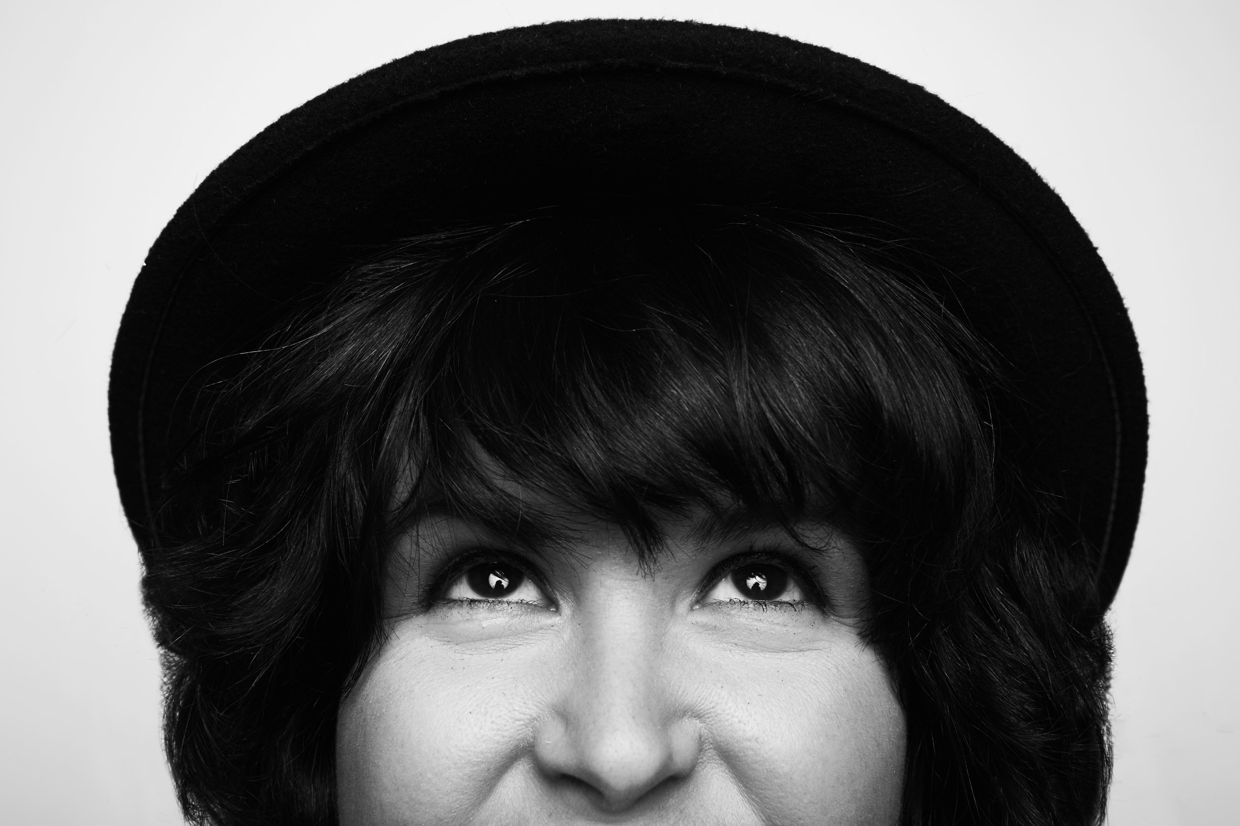 The same session, black and white, the eyes just under the brim