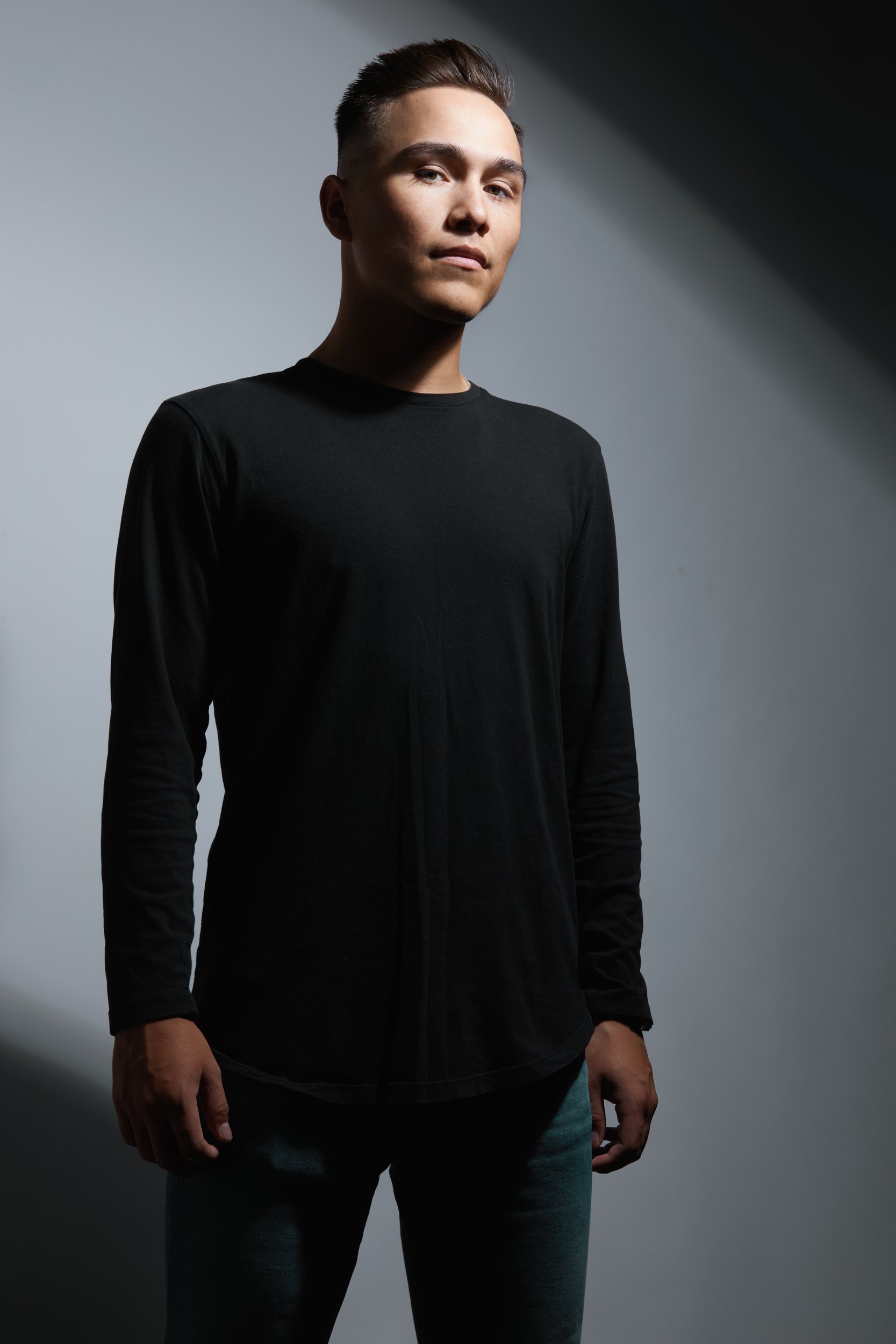 The same session, a black long-sleeve against grey, in a patch of light