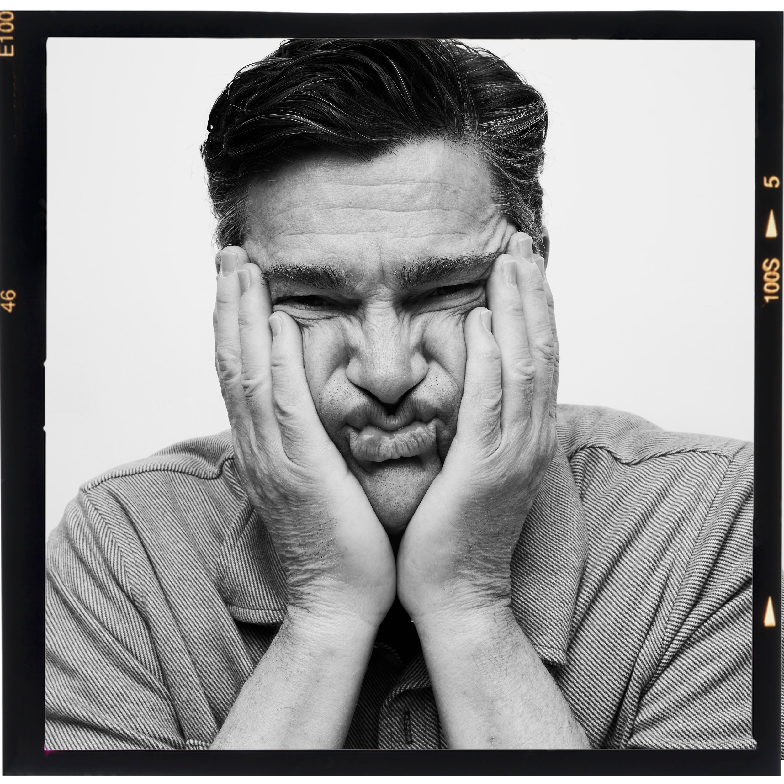 The same roll, face squeezed between both hands