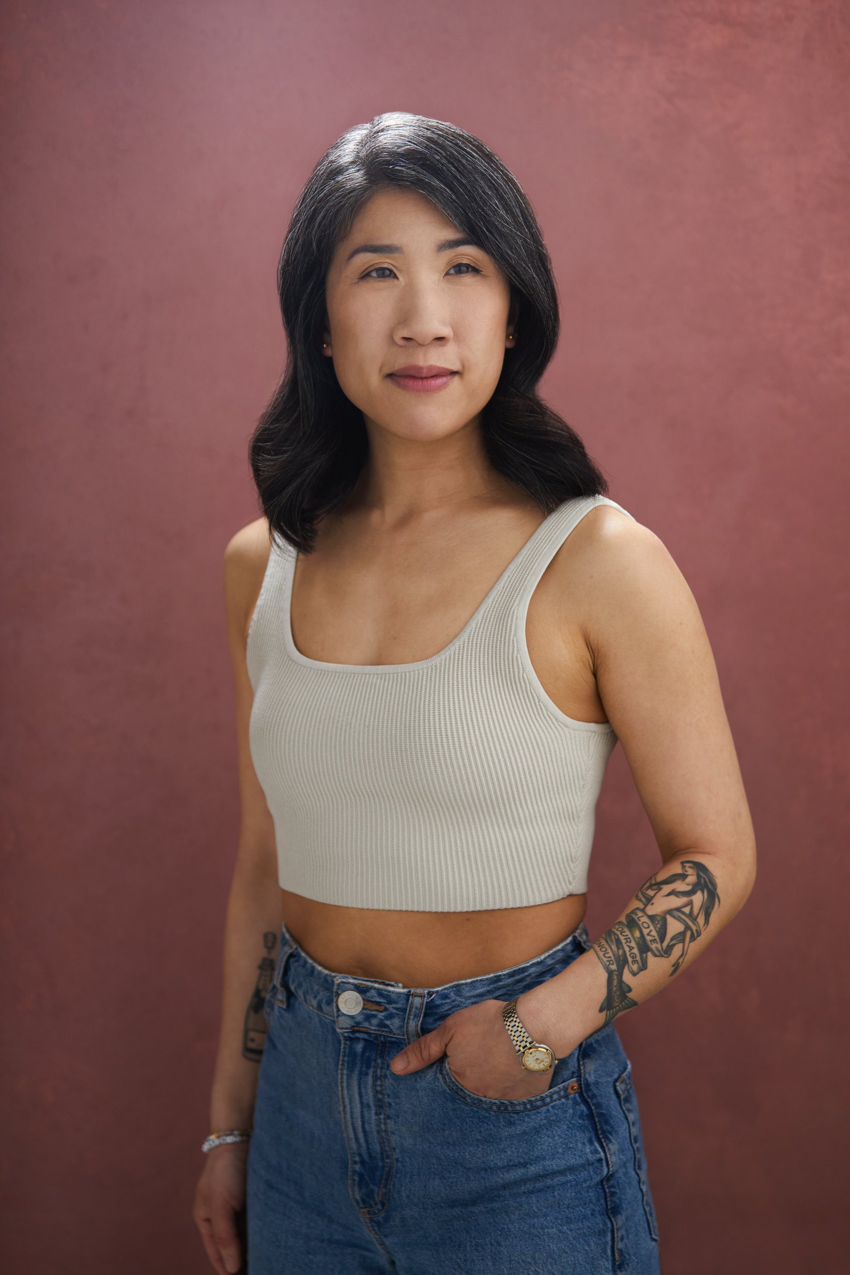 The same session, a cream tank top and jeans against mauve