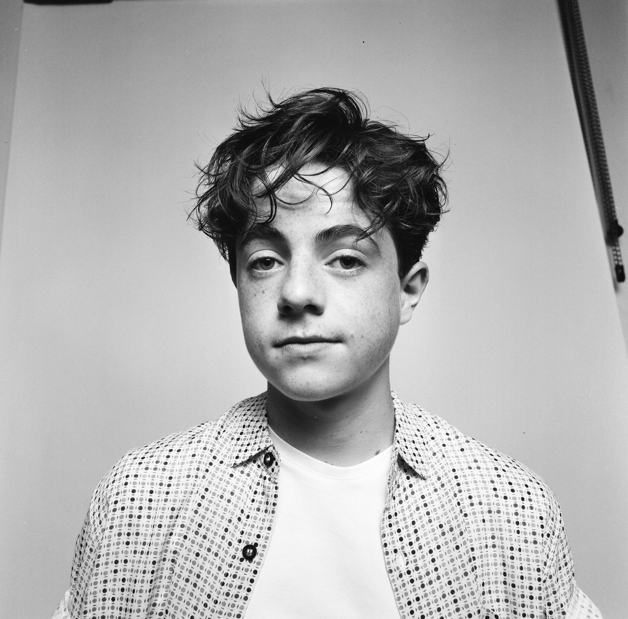 On film, a checked shirt, the stand left in the shot
