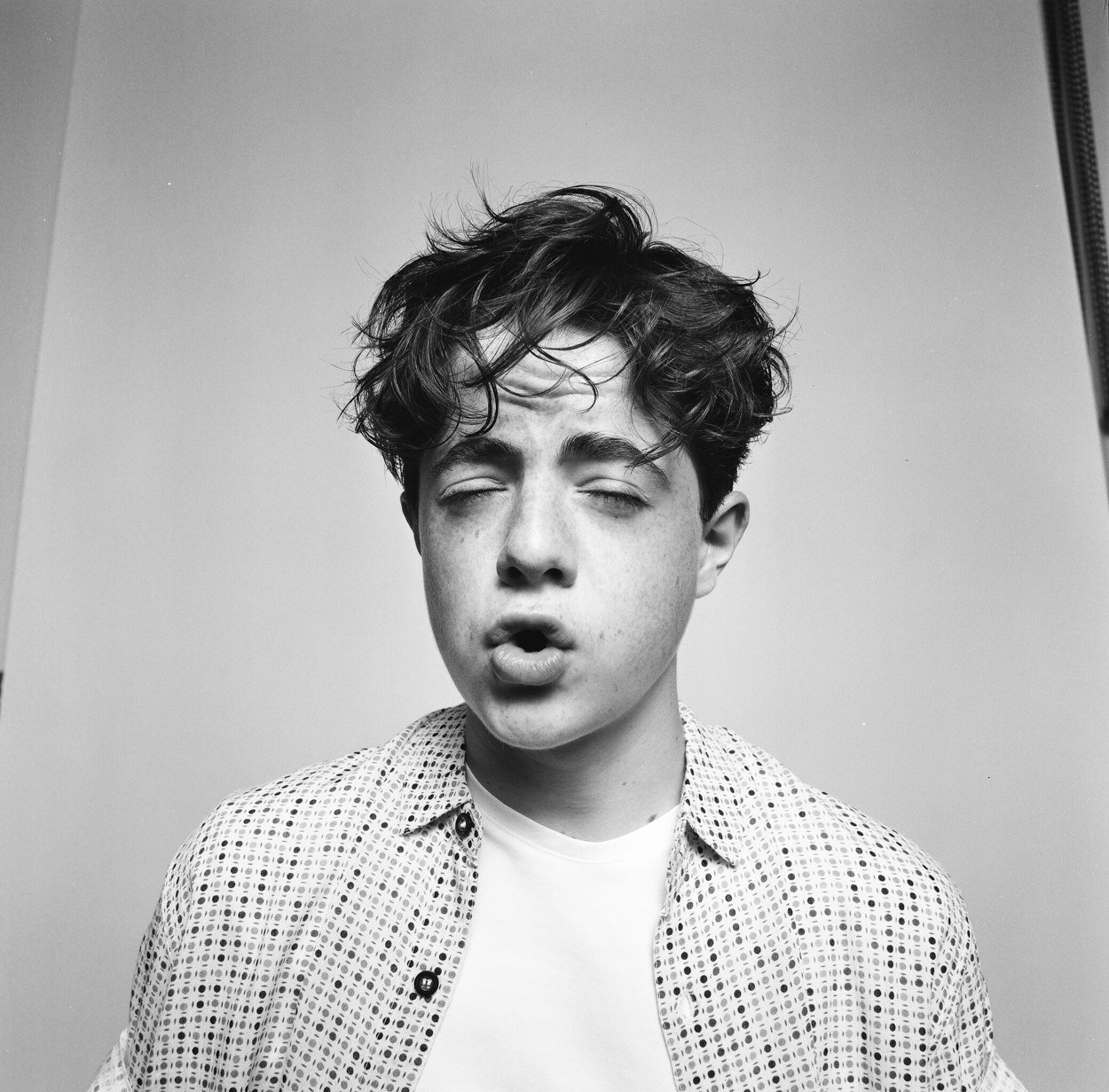 On film, eyes closed, mid-word