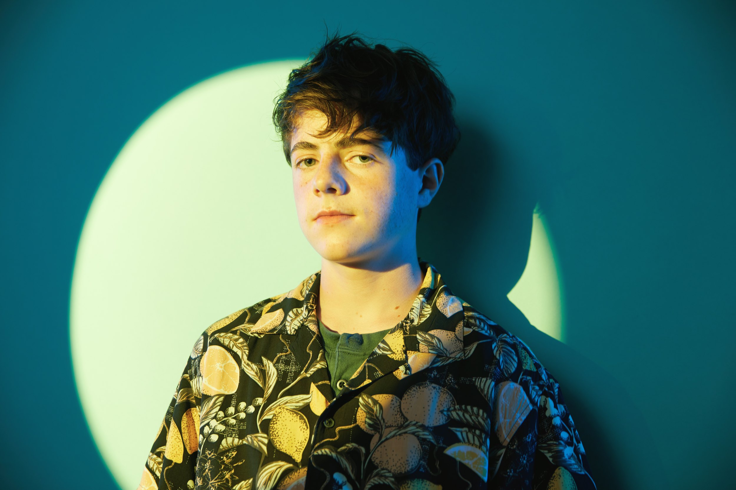 The floral shirt, closer, in the circle of green light