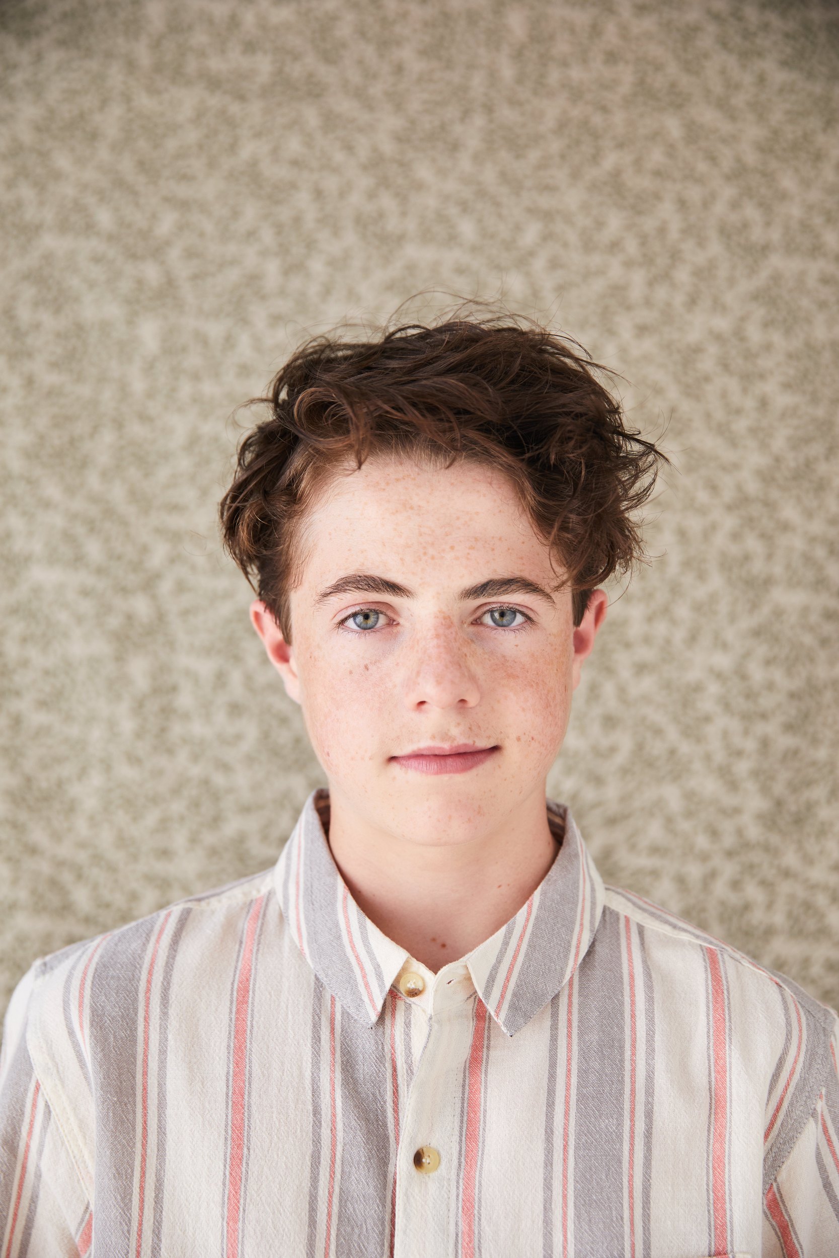 A striped shirt against a mottled beige backdrop