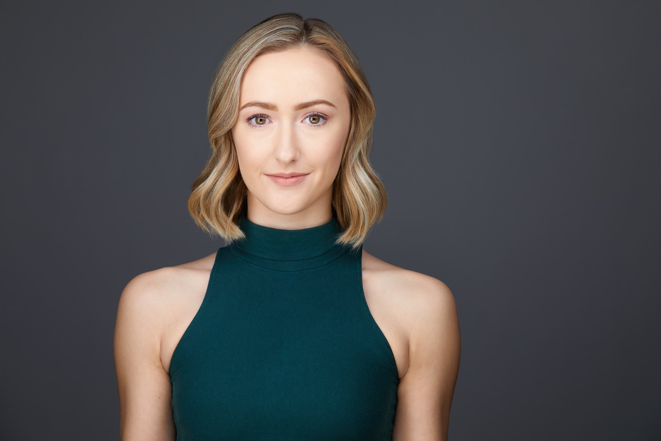 Dance headshot: a green halter top against grey