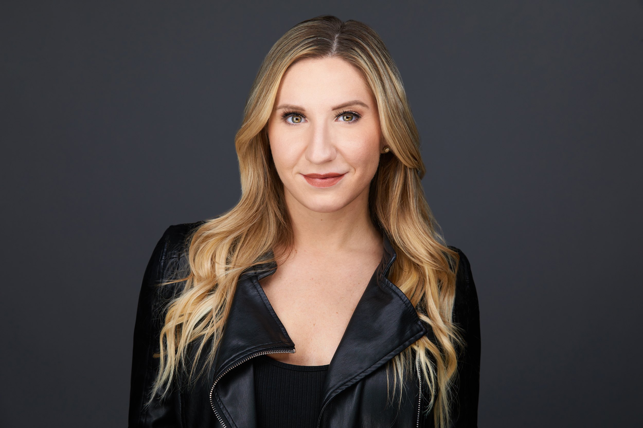 Dance headshot: a black leather jacket against grey