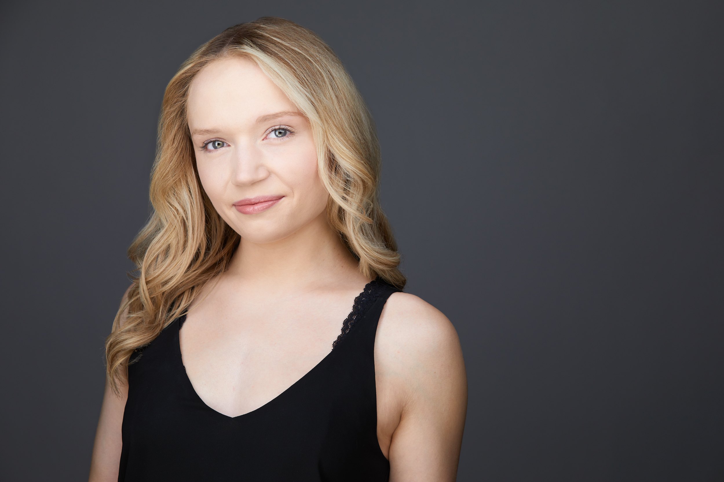 Dance headshot: blonde, a black top against grey