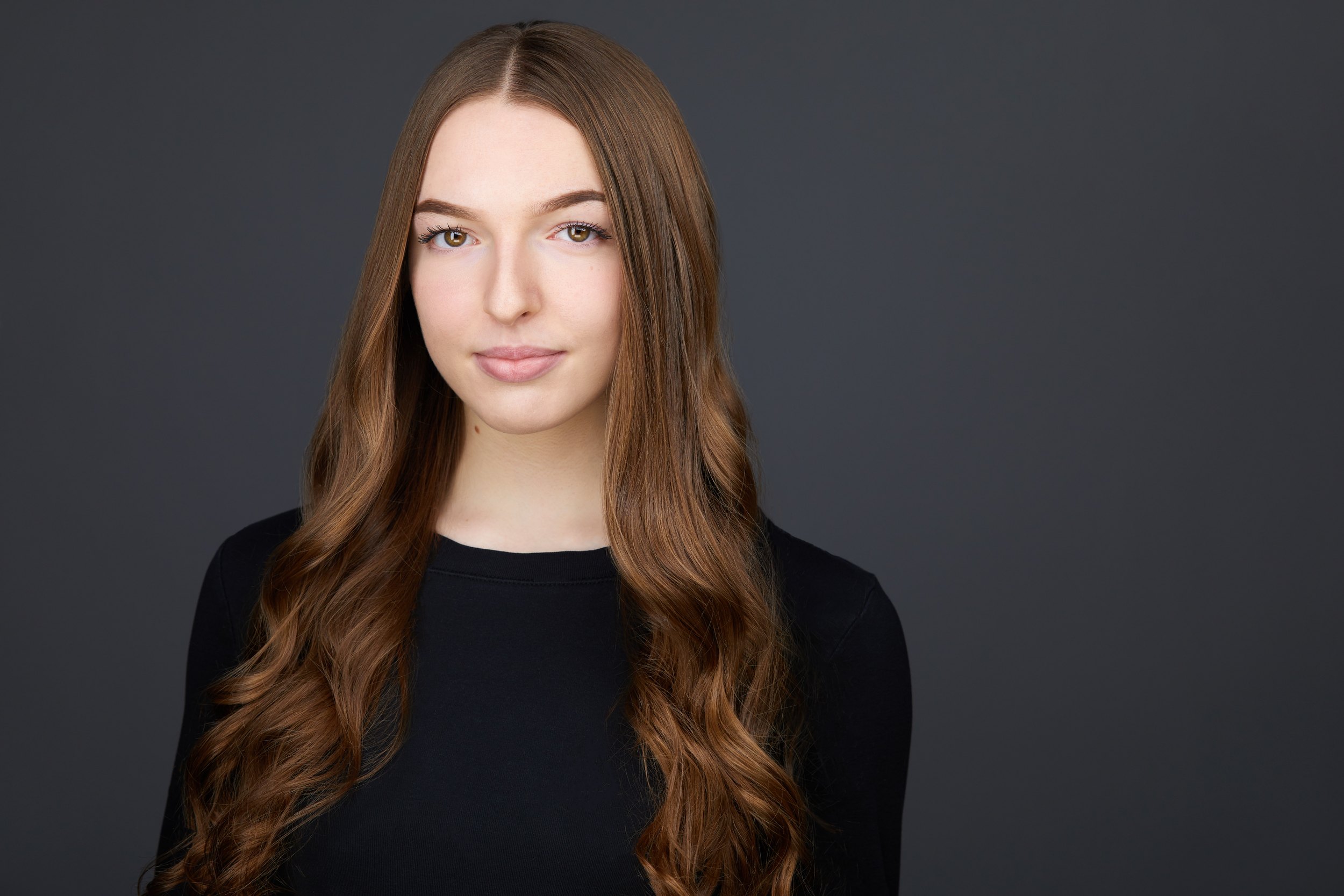 Dance headshot: a black long-sleeved top against grey