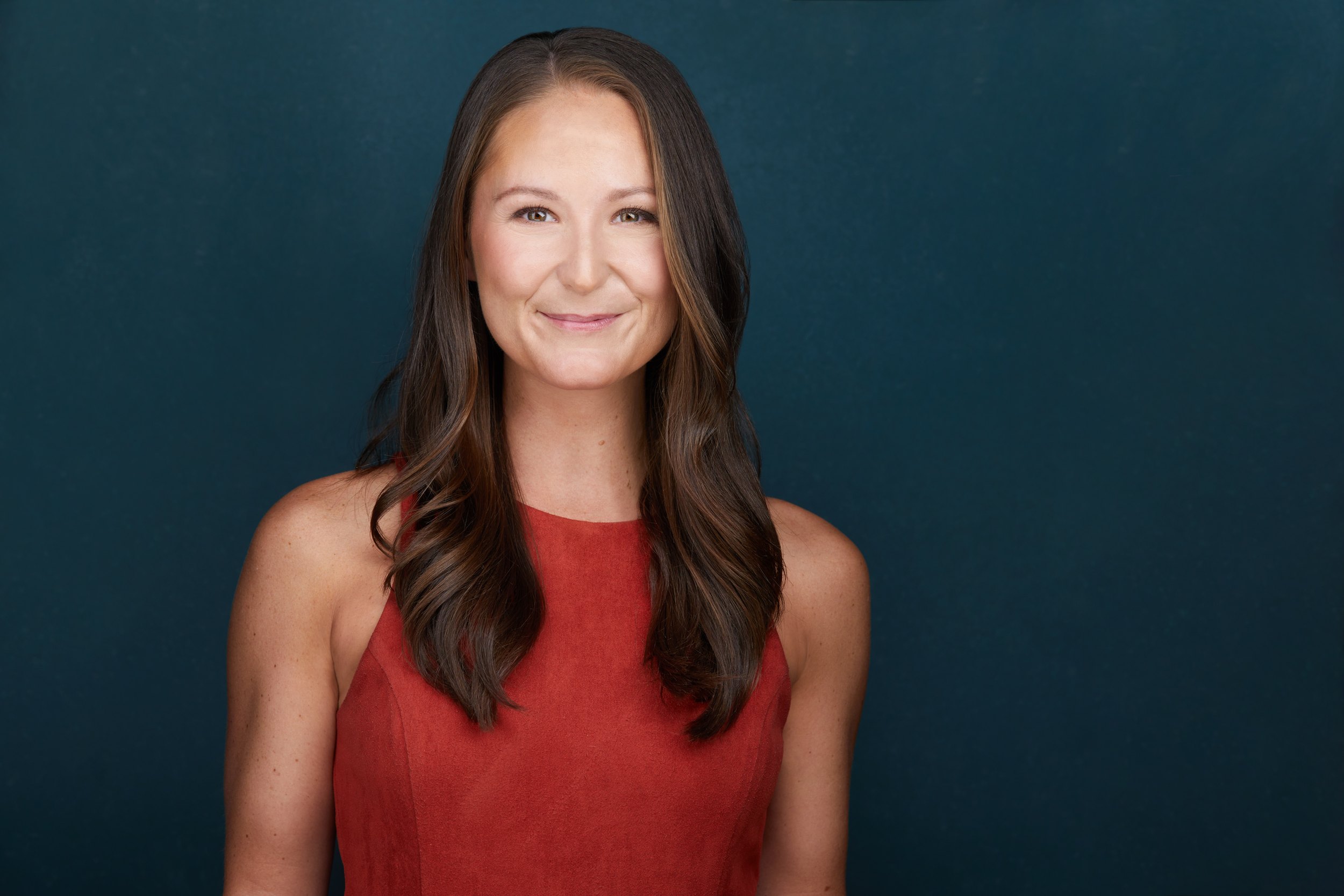 Dance headshot: a rust top against teal