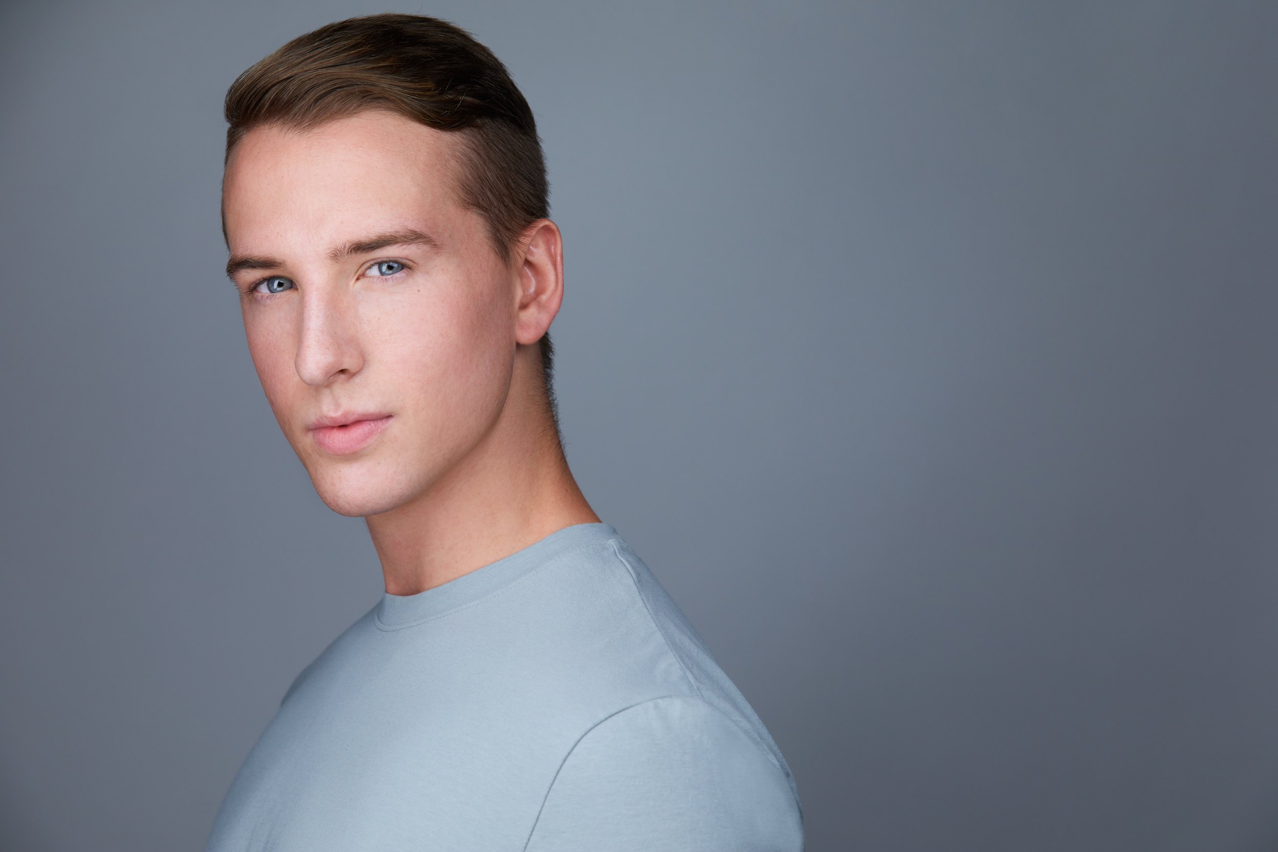 Dance headshot: a pale grey t-shirt against grey