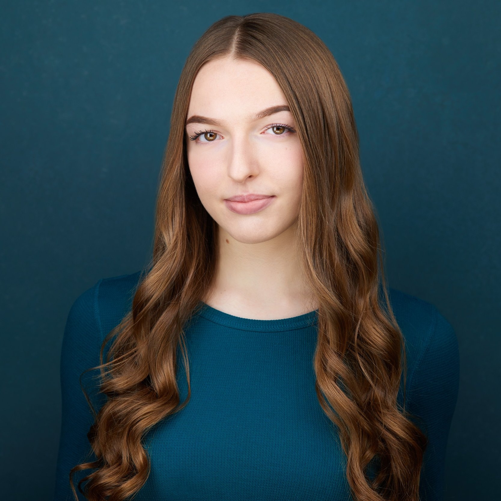 Dance headshot: a teal top against teal