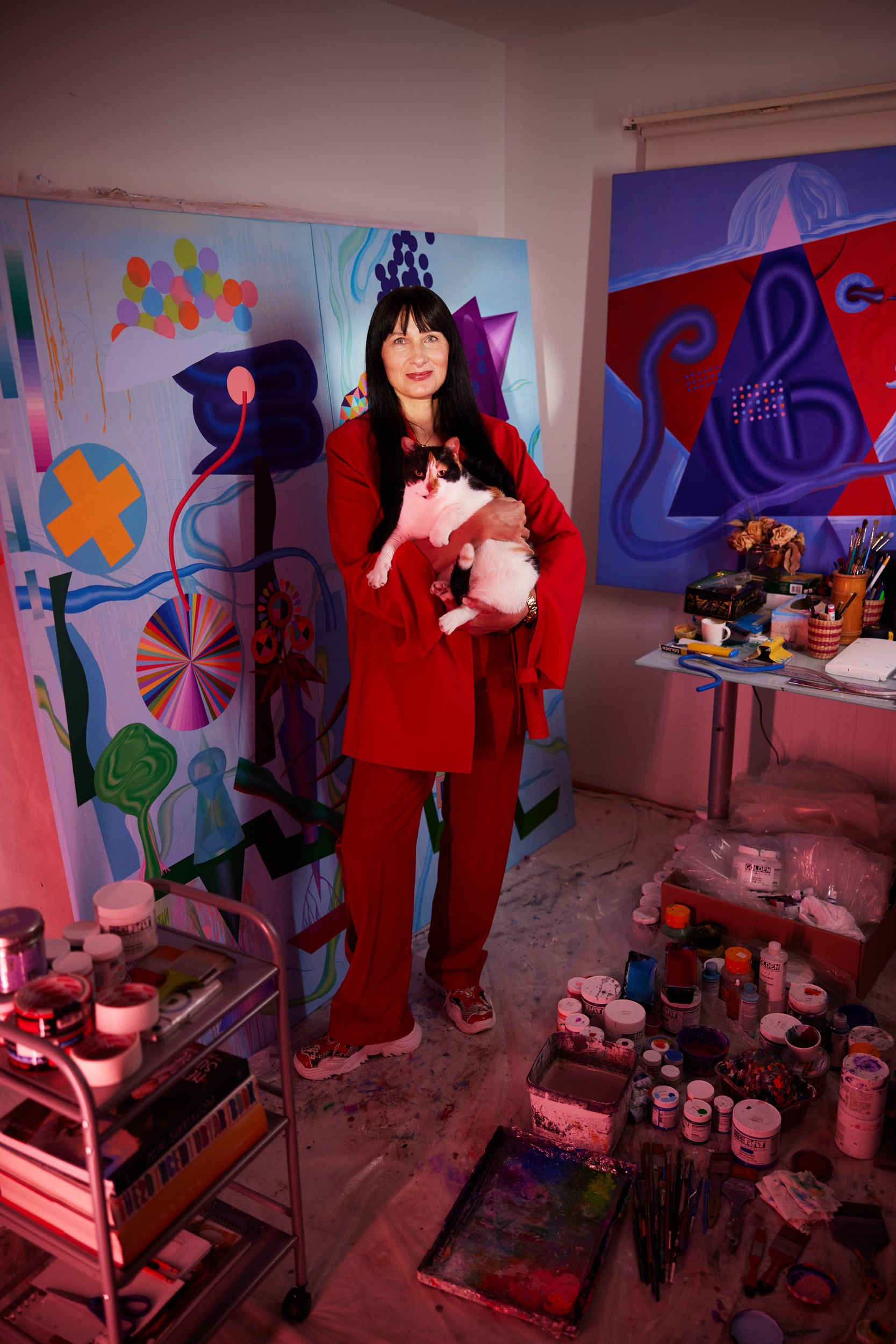 Oksana Movchan in the same studio, holding Kitsia