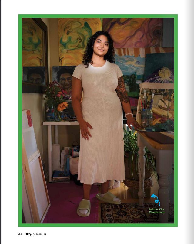 The opening page: Kira Chankasingh in a cream dress in her studio, her paintings behind her