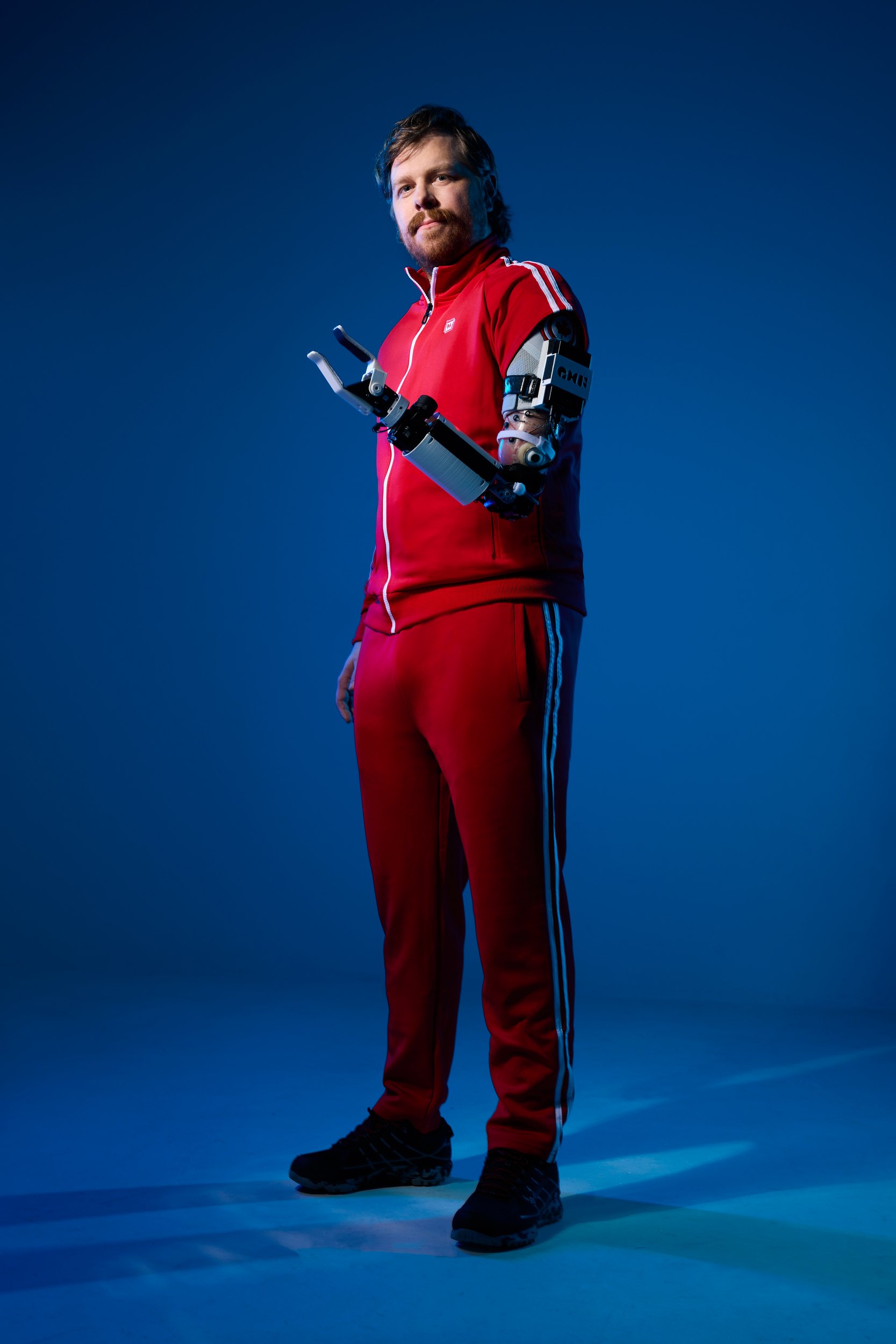 Full length in the red tracksuit, the blue running dark at the edges