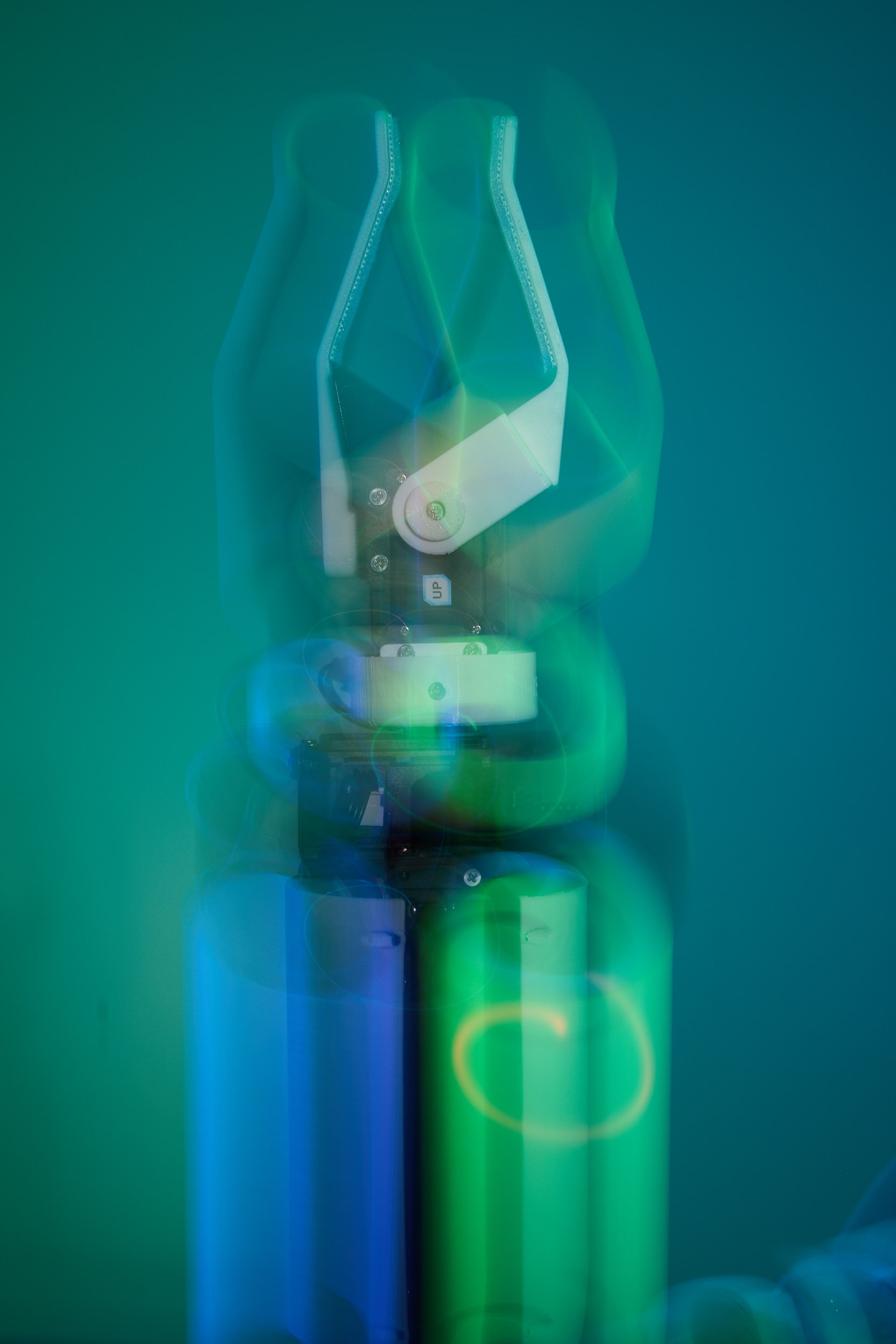 The arm alone, green, doubled and tripled through a long exposure