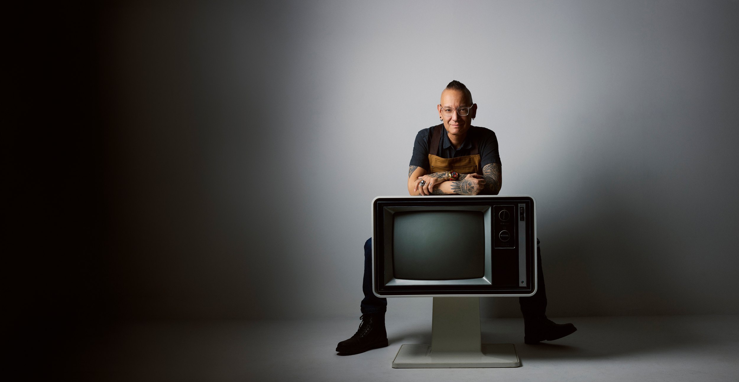 Wider, the television low in the frame and the grey running out either side