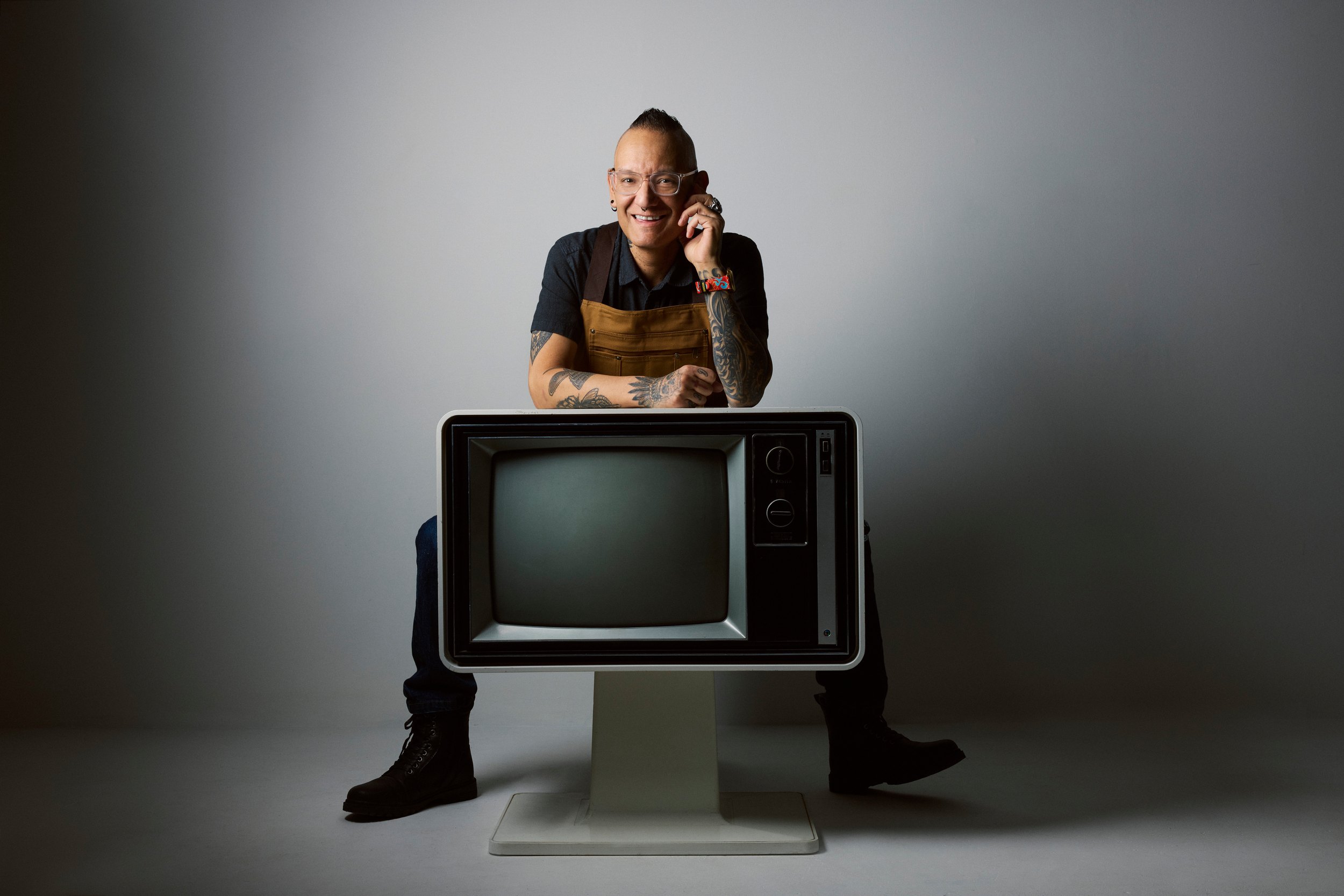 Seated on the television, hands together