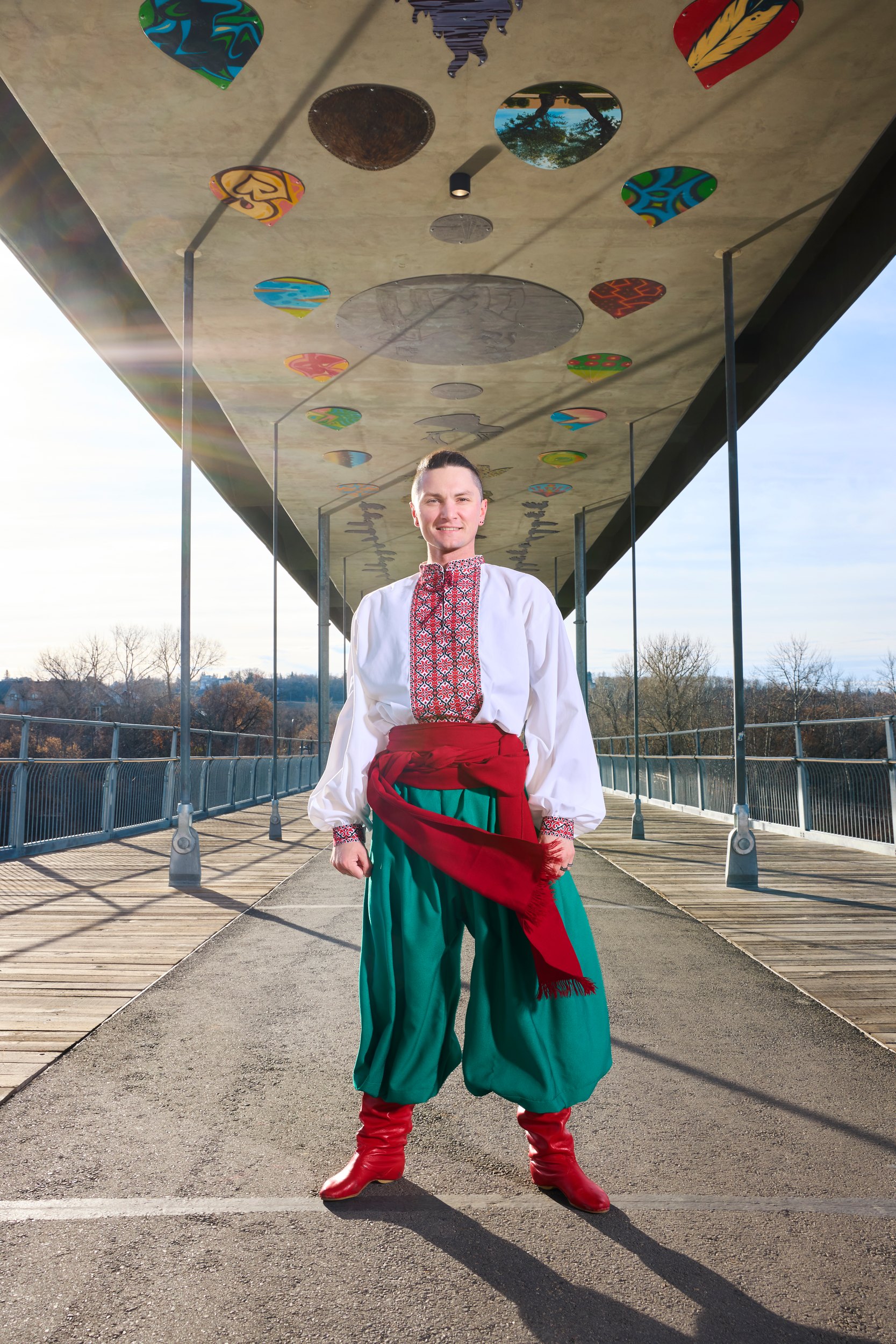 The frame the spread ran: standing on the bridge in embroidered shirt and red boots, the deck converging behind him