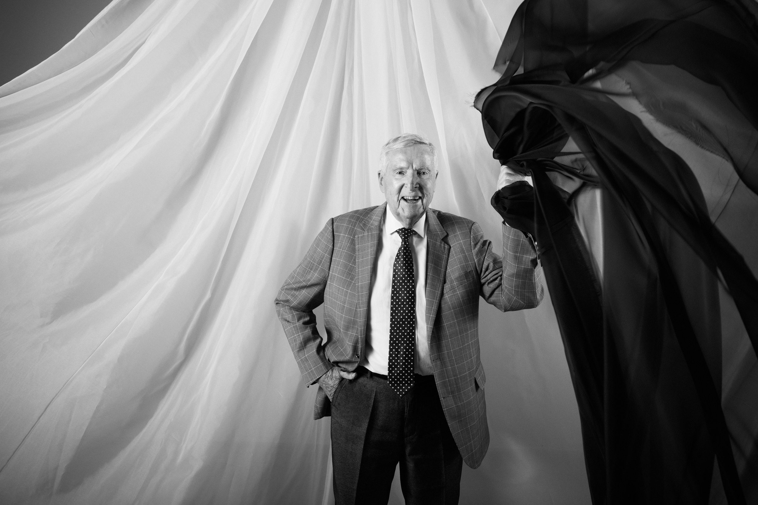 A man with the cloth thrown across the frame behind him