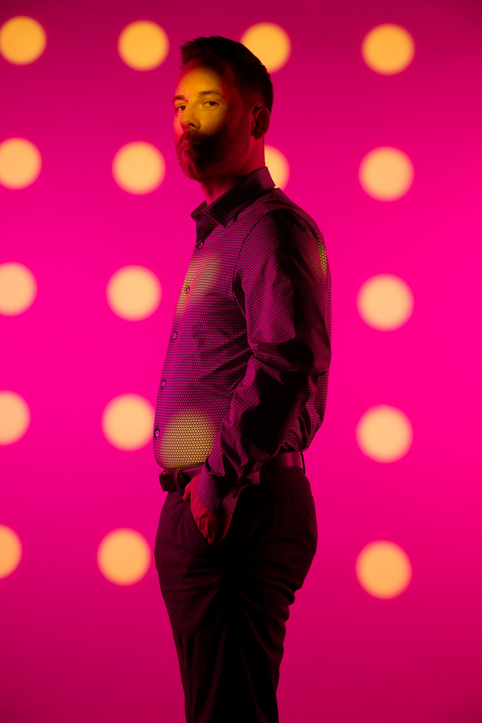 The same man turned side on, the dotted light running down the length of him