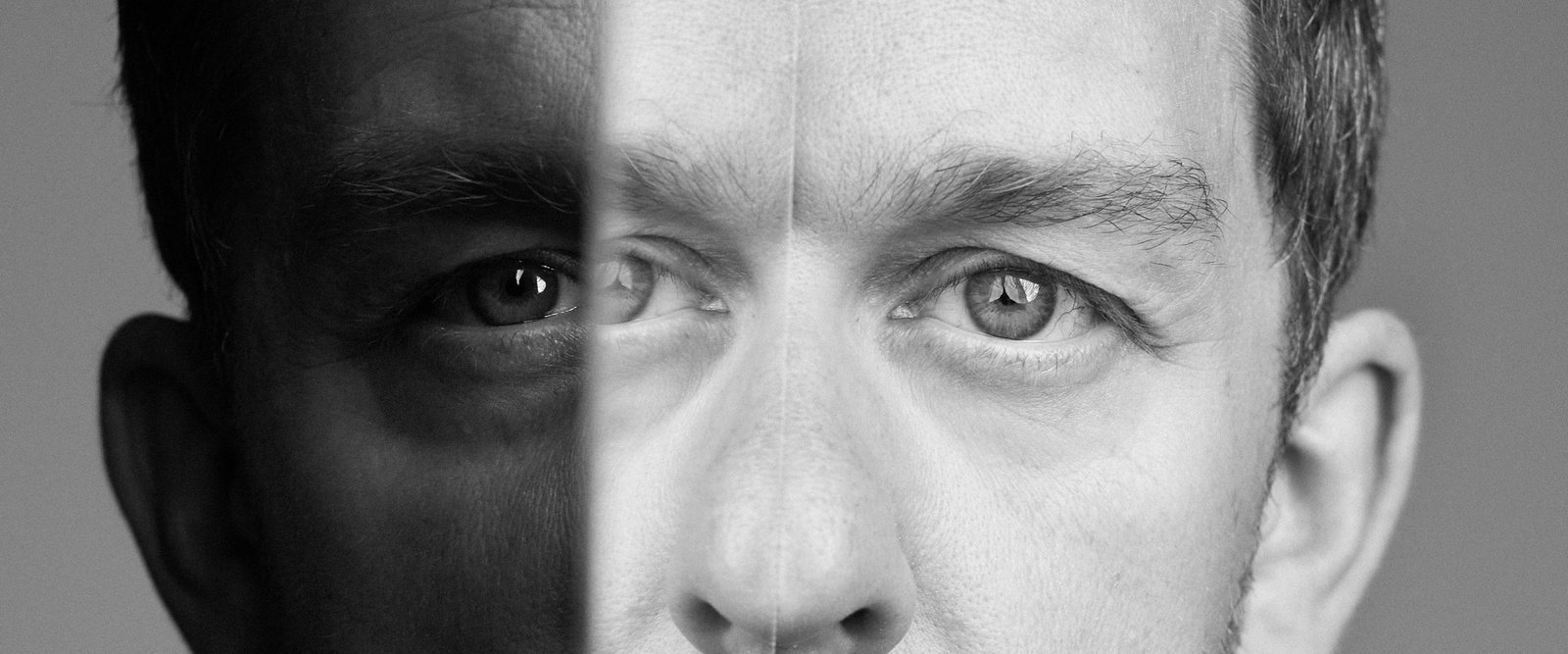 A close crop of Ryan Parker’s eyes, split down the middle by the edge of a mirror, so a third eye seems to sit between the two