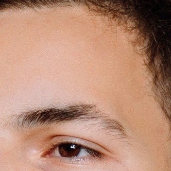 Real photo: a close-up of a young man’s forehead and eyebrow