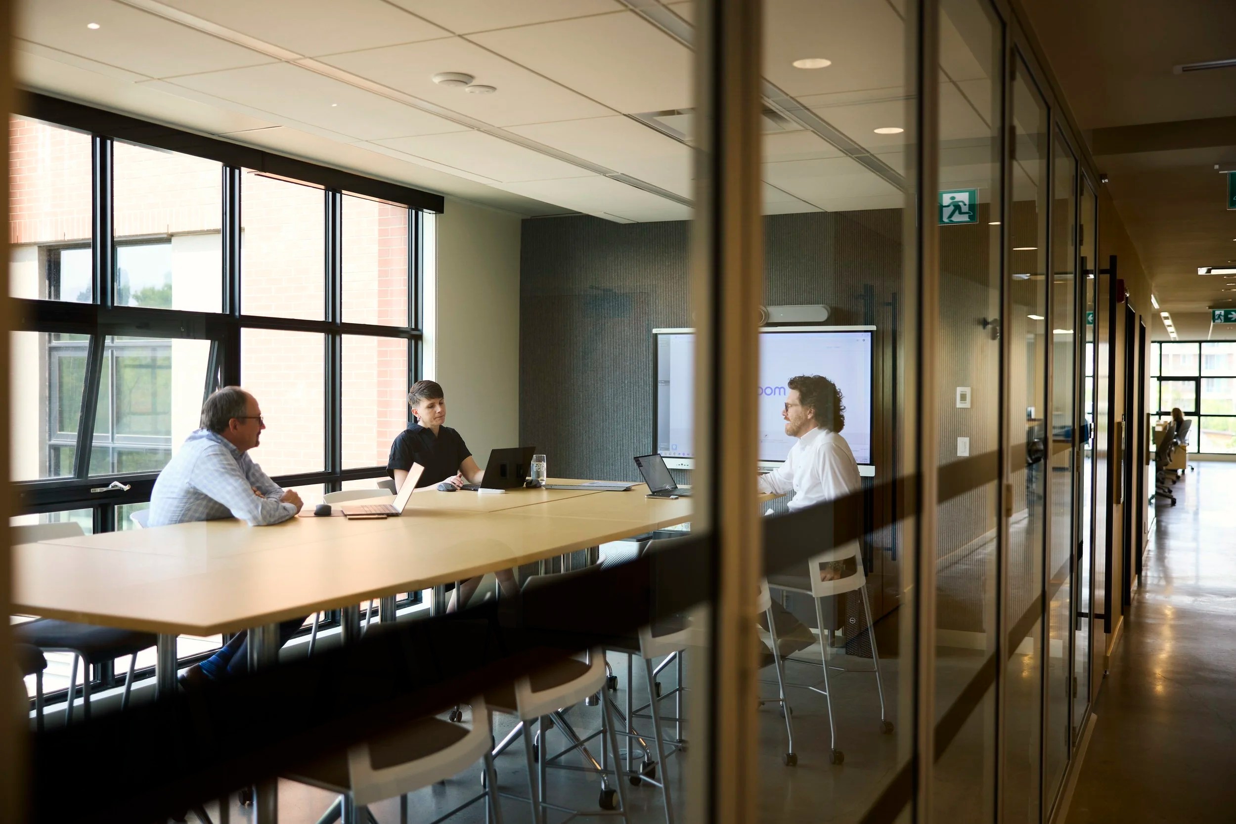 A meeting at a long table by the windows, Calgary