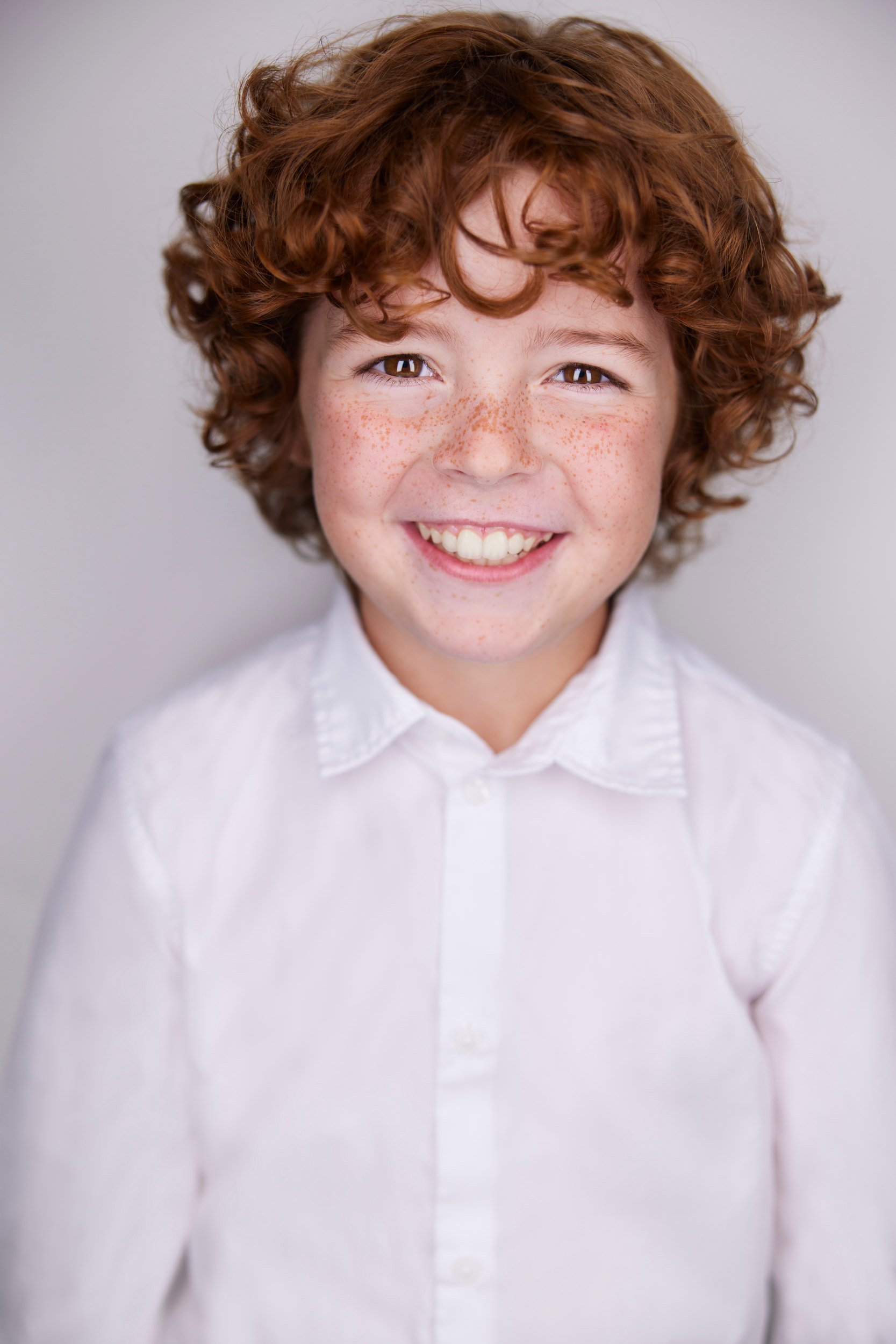 The same session, a white shirt, grinning