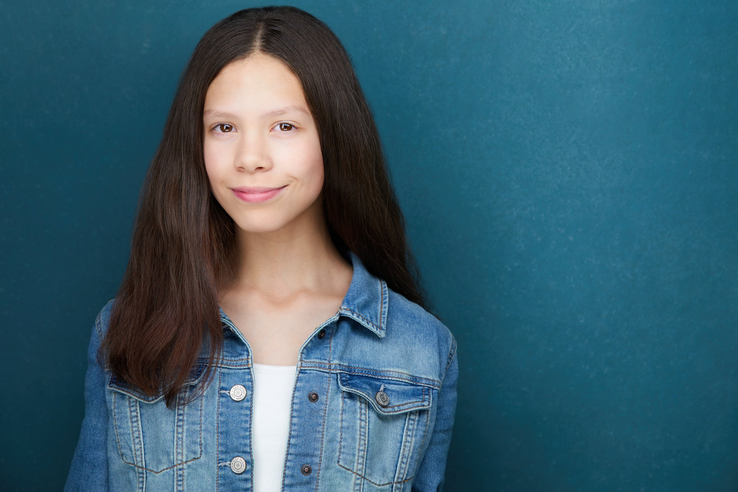 Kids and teens headshot: a denim jacket over white against teal