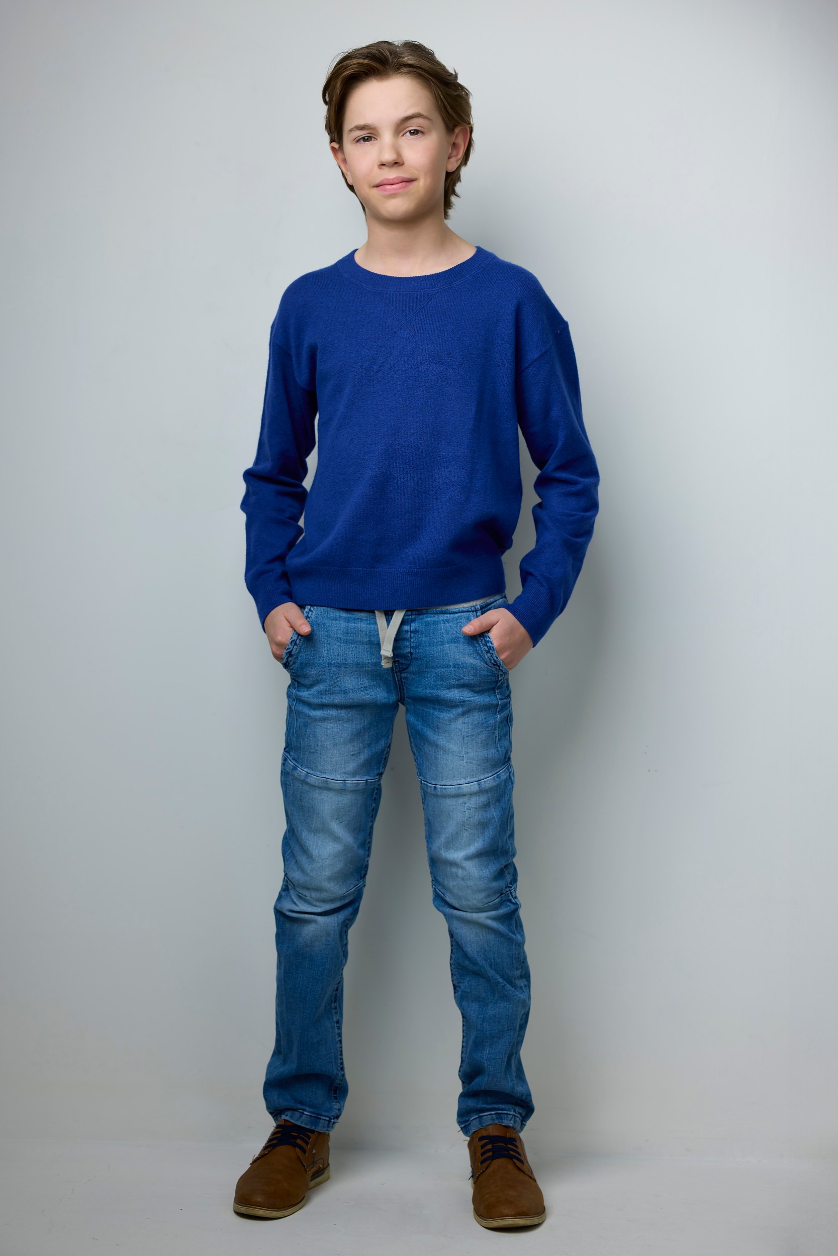 The same session, a blue sweater and jeans, head to toe on white