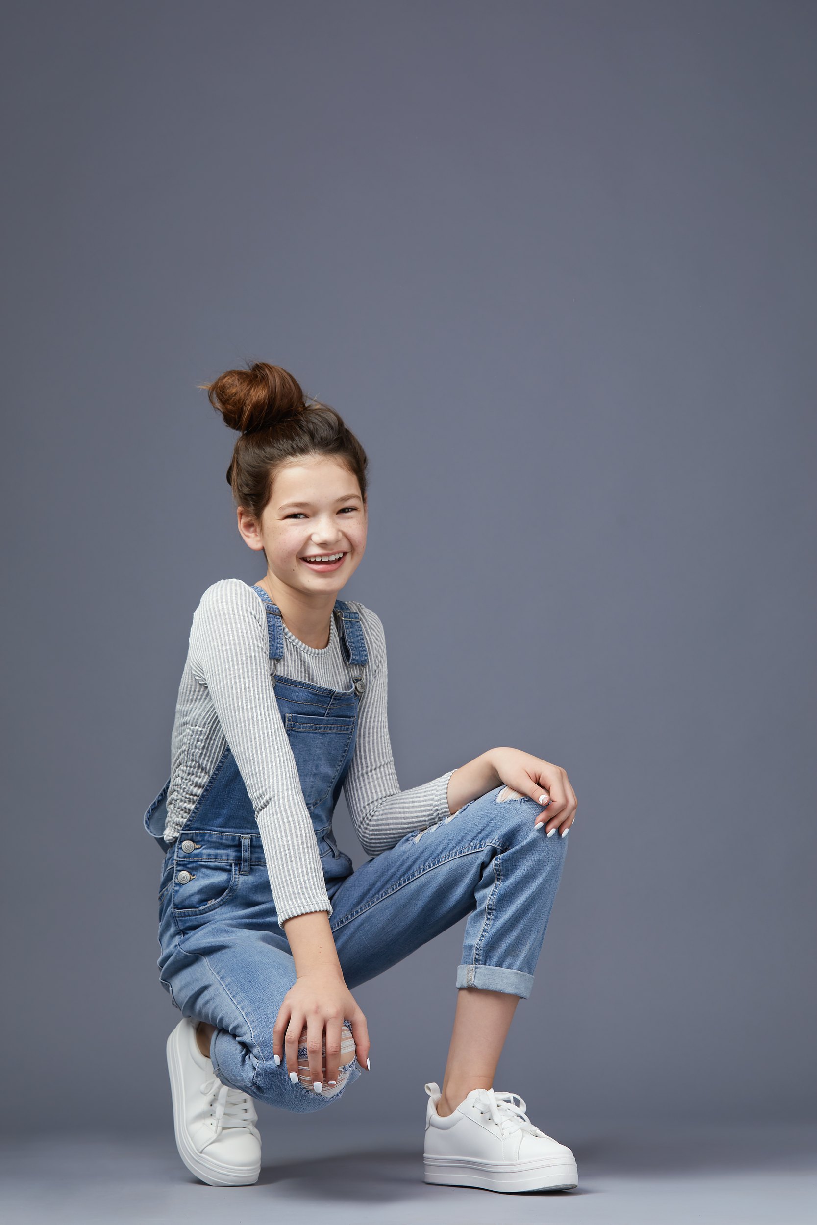 The same session, overalls, crouched and laughing