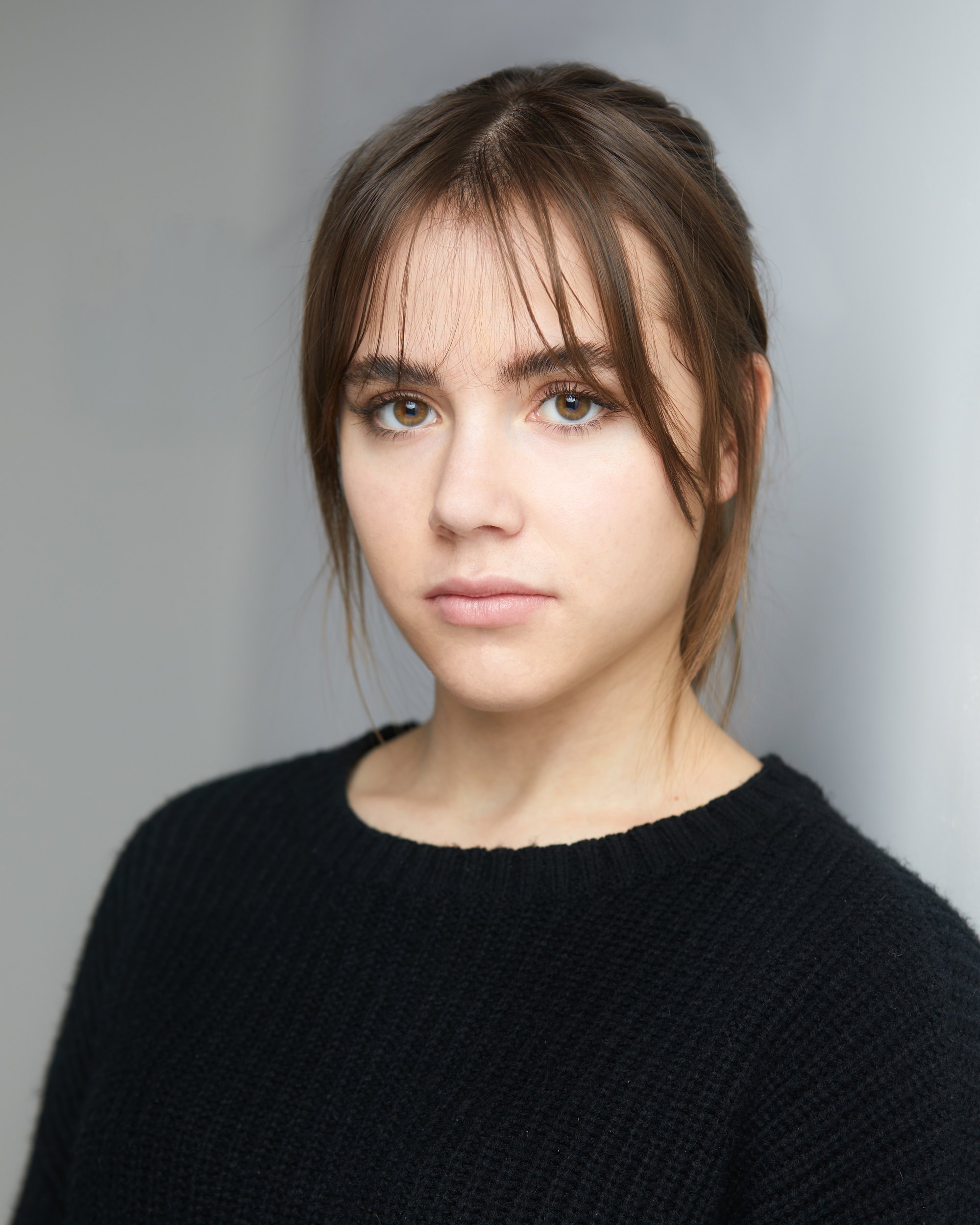 The same session, a black sweater against the wall of light