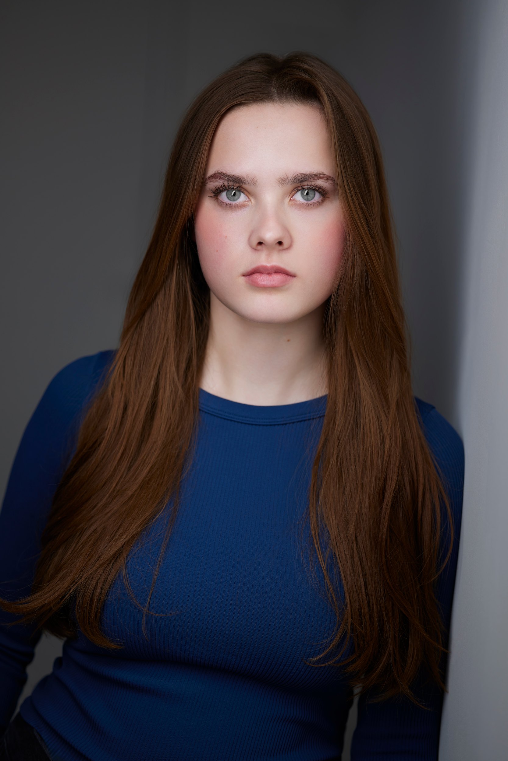 Kids and teens headshot: a blue top against grey
