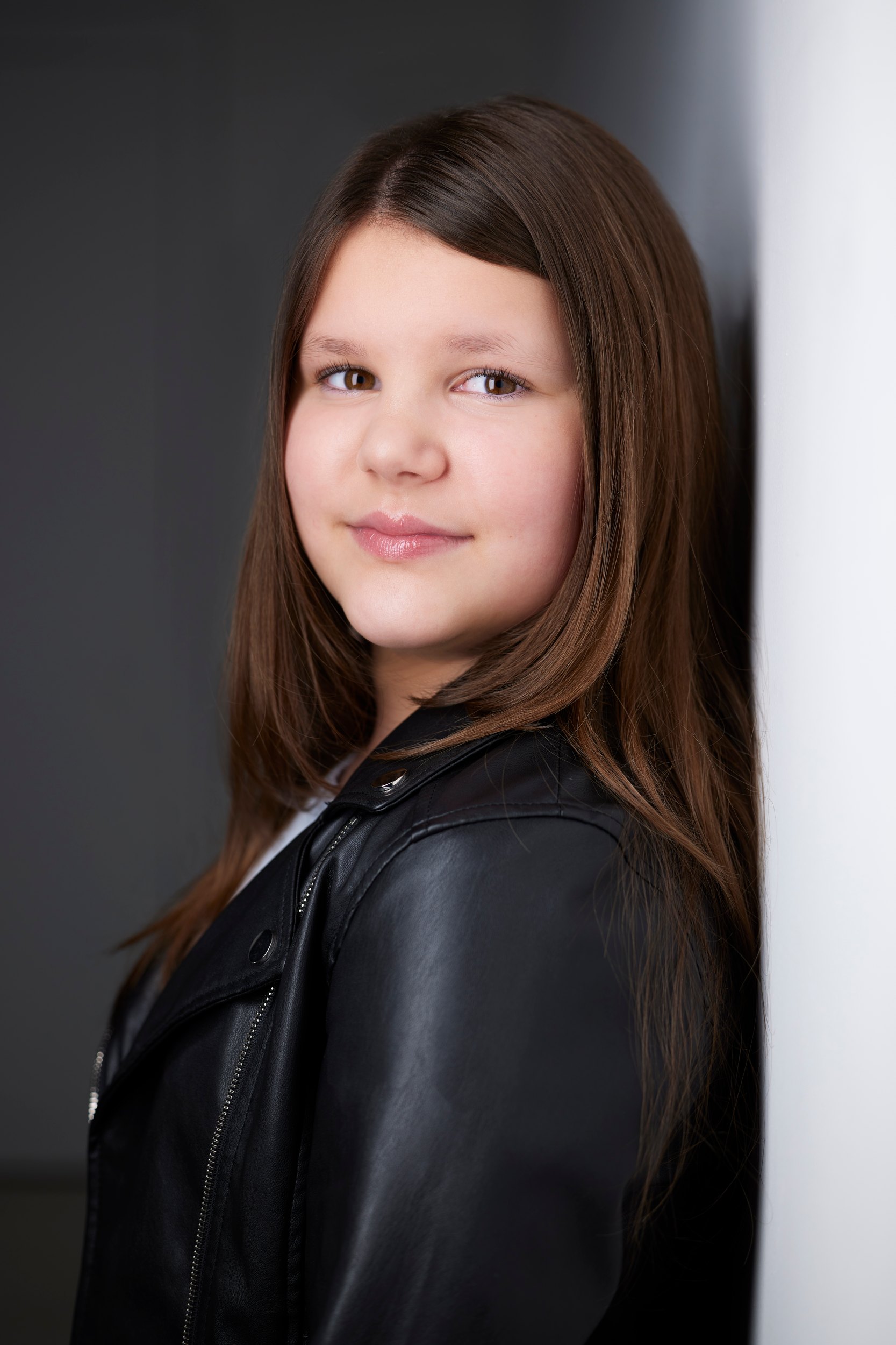 Kids and teens headshot: a black leather jacket against the wall of light