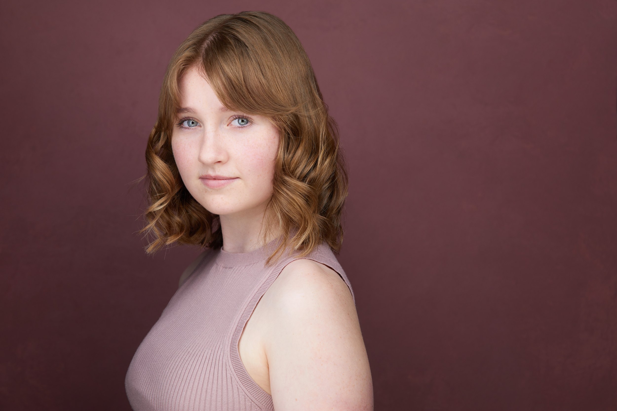 Kids and teens headshot: a lilac top against plum, turned
