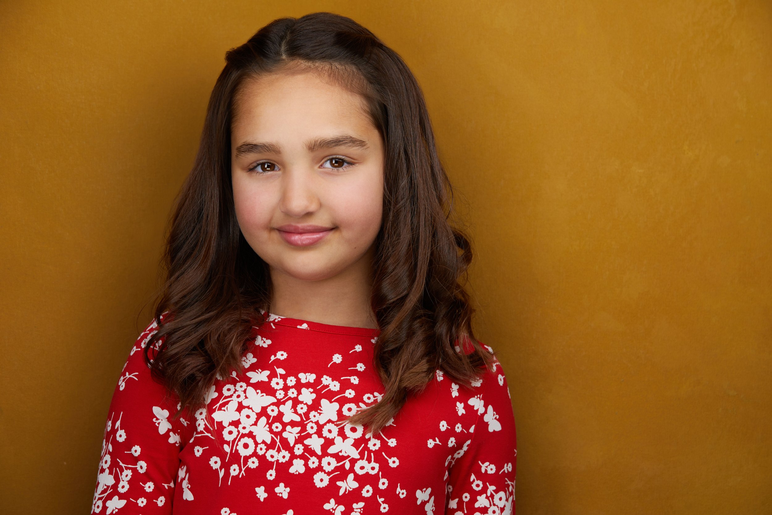 Kids and teens headshot: a red floral top against mustard
