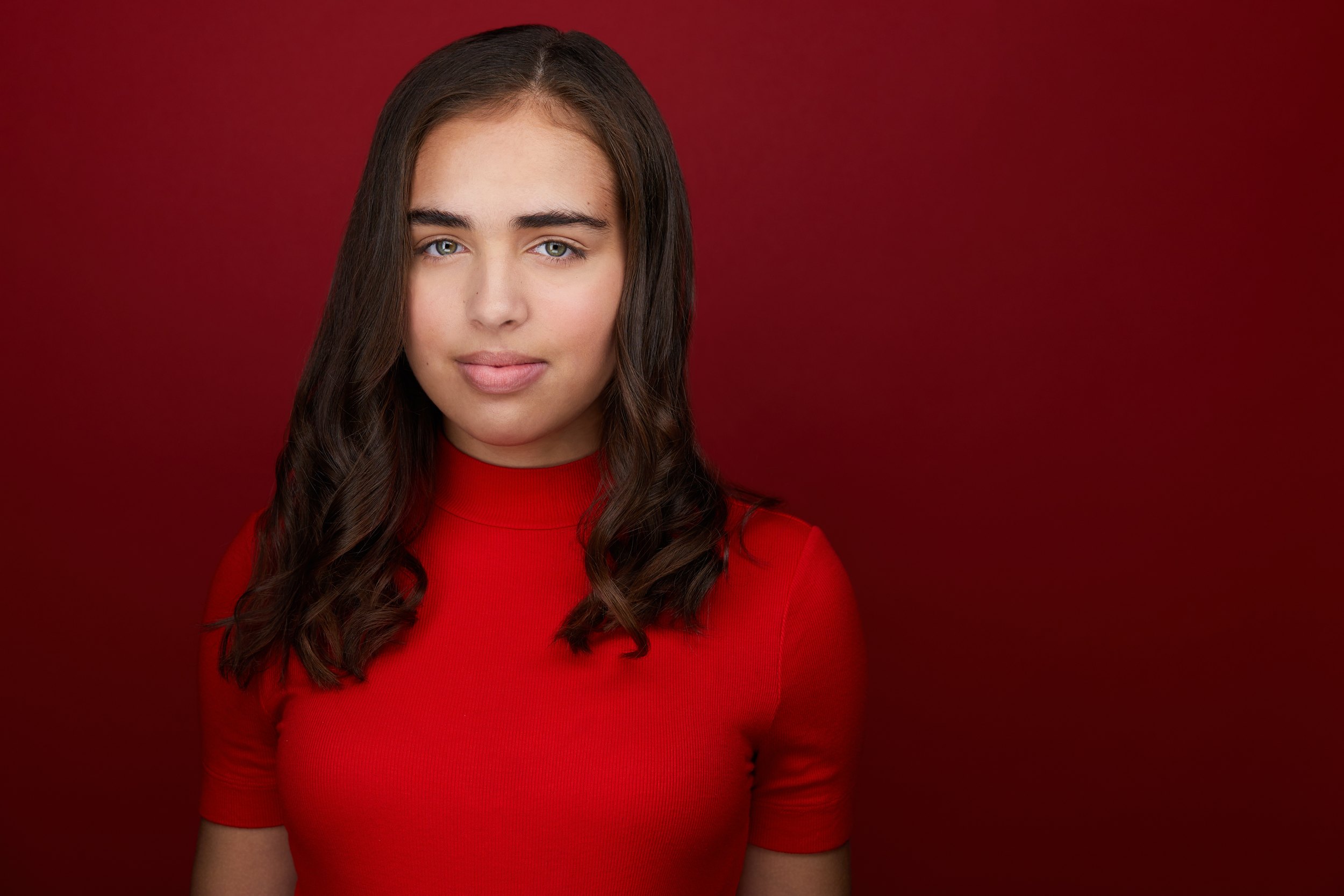 Kids and teens headshot: a red turtleneck against deep red