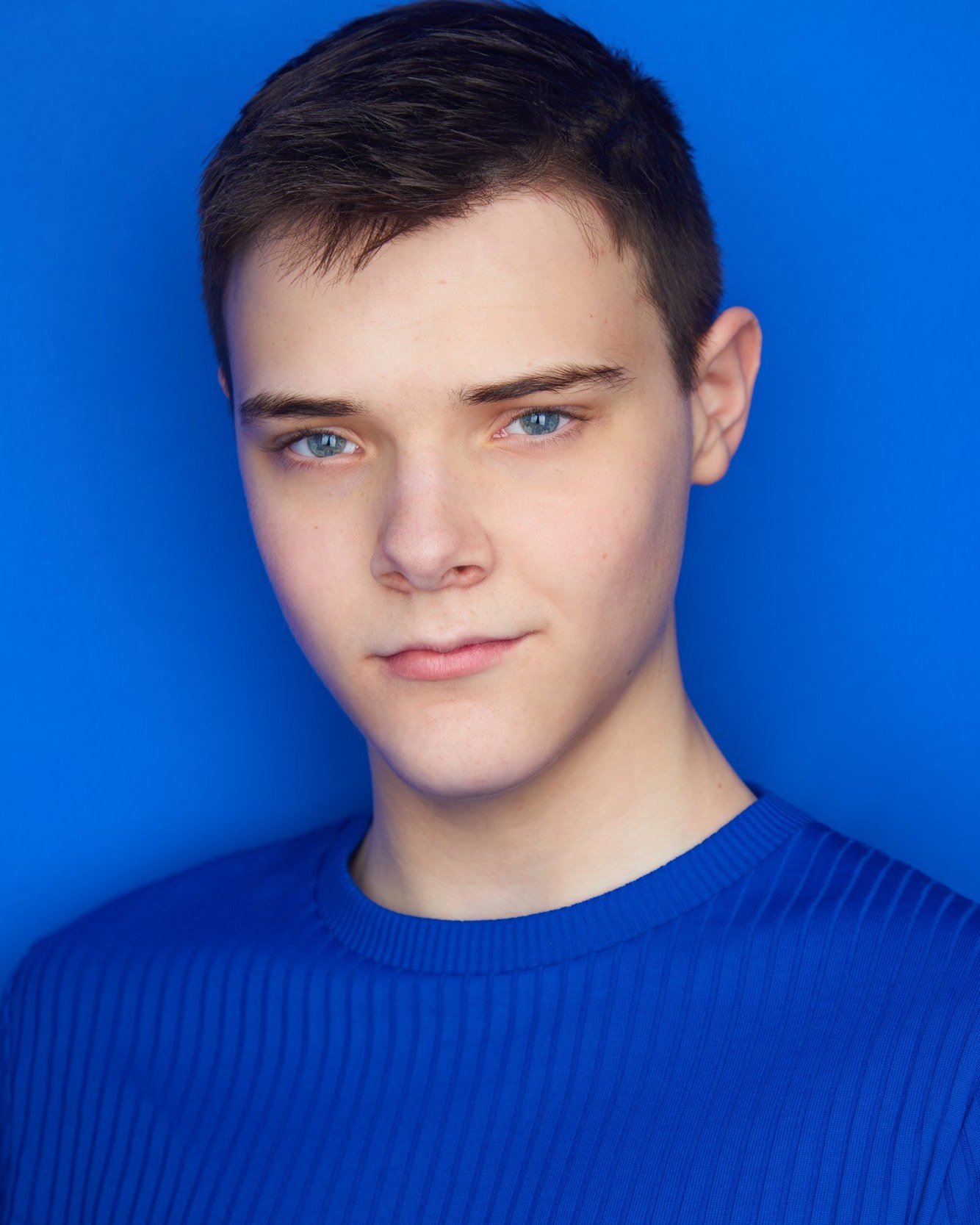 Kids and teens headshot: a blue sweater against electric blue