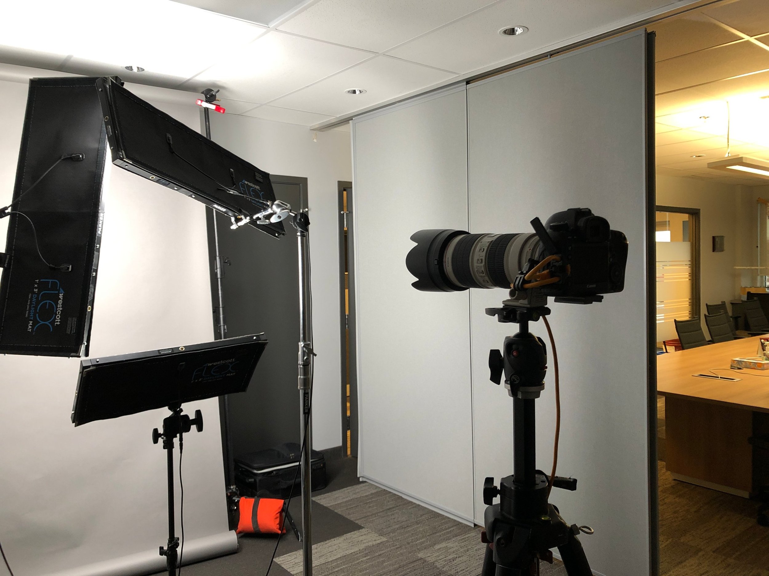 Ryan Parker’s on-location headshot setup, lights, backdrop and tethered screen, in a boardroom